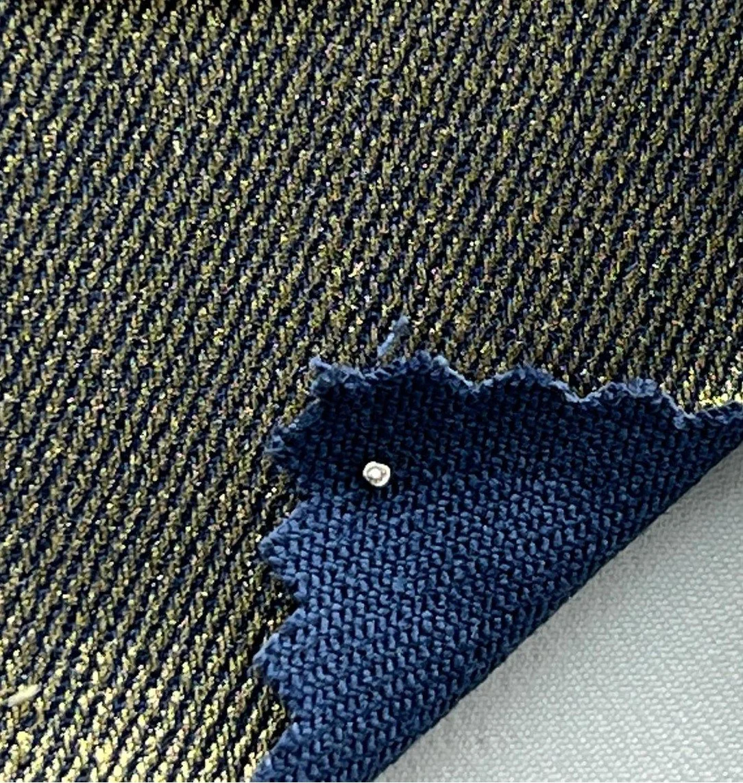 Close-up of moto pants fabric in gold