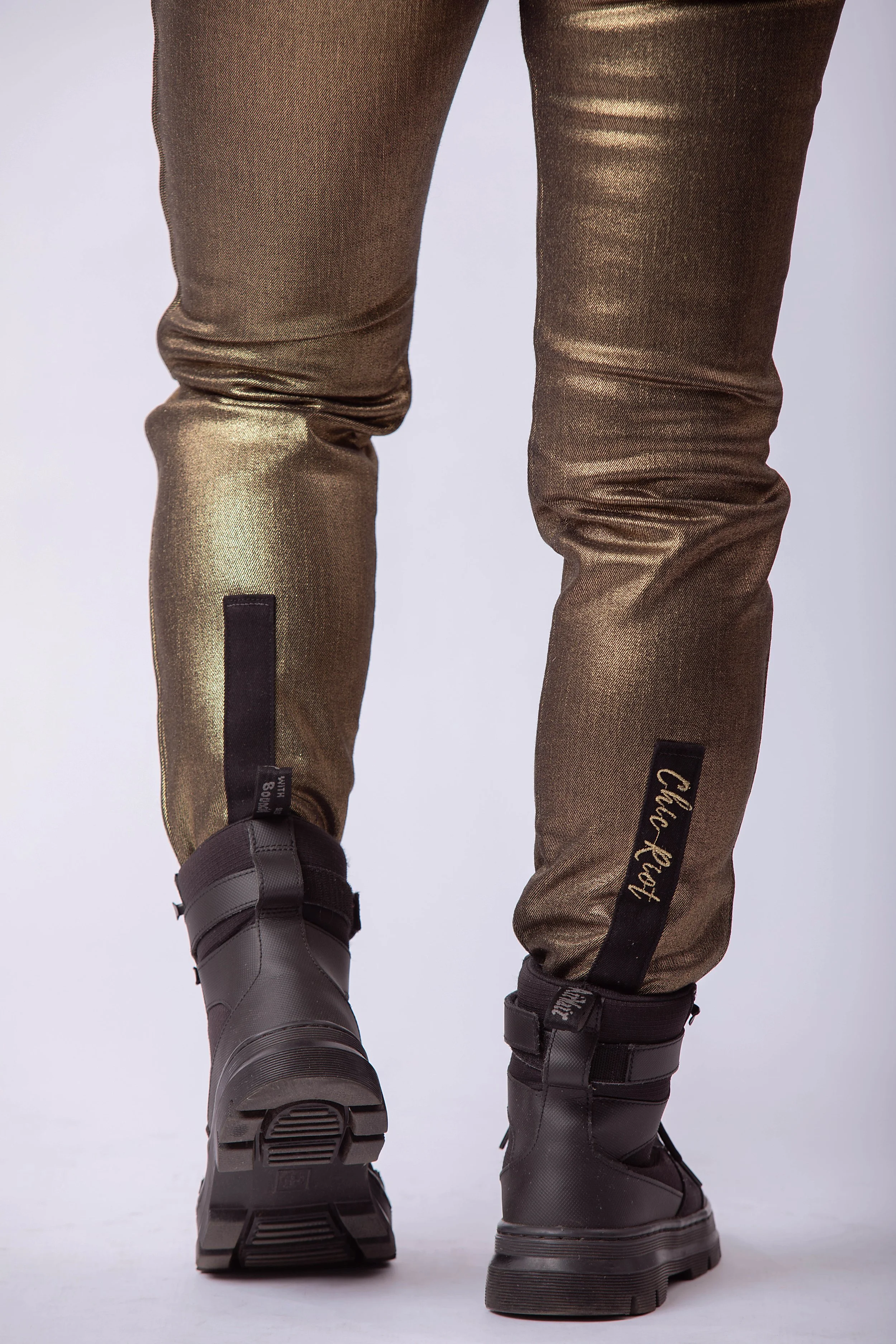 Back view of metallic gold moto pants tapered leg fit