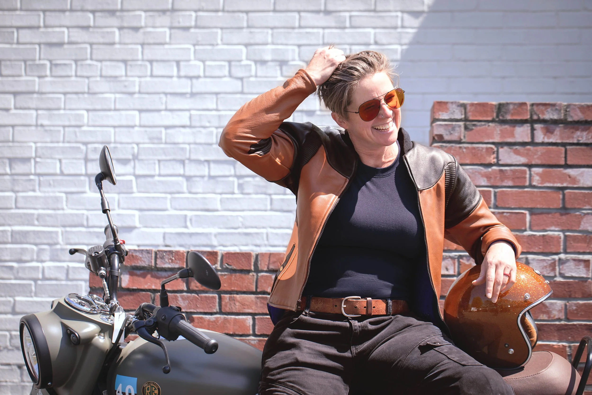 Woman outside sitting on motorcycle