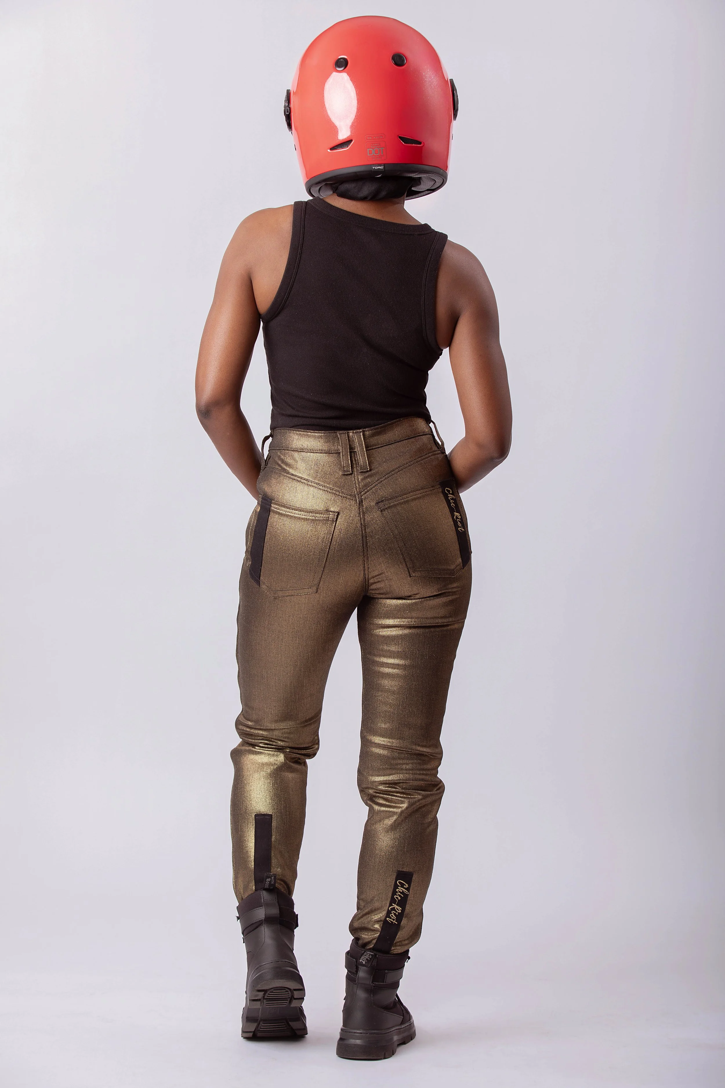 Back view of metallic gold moto pants with high waist, rear pockets, and tapered leg fit