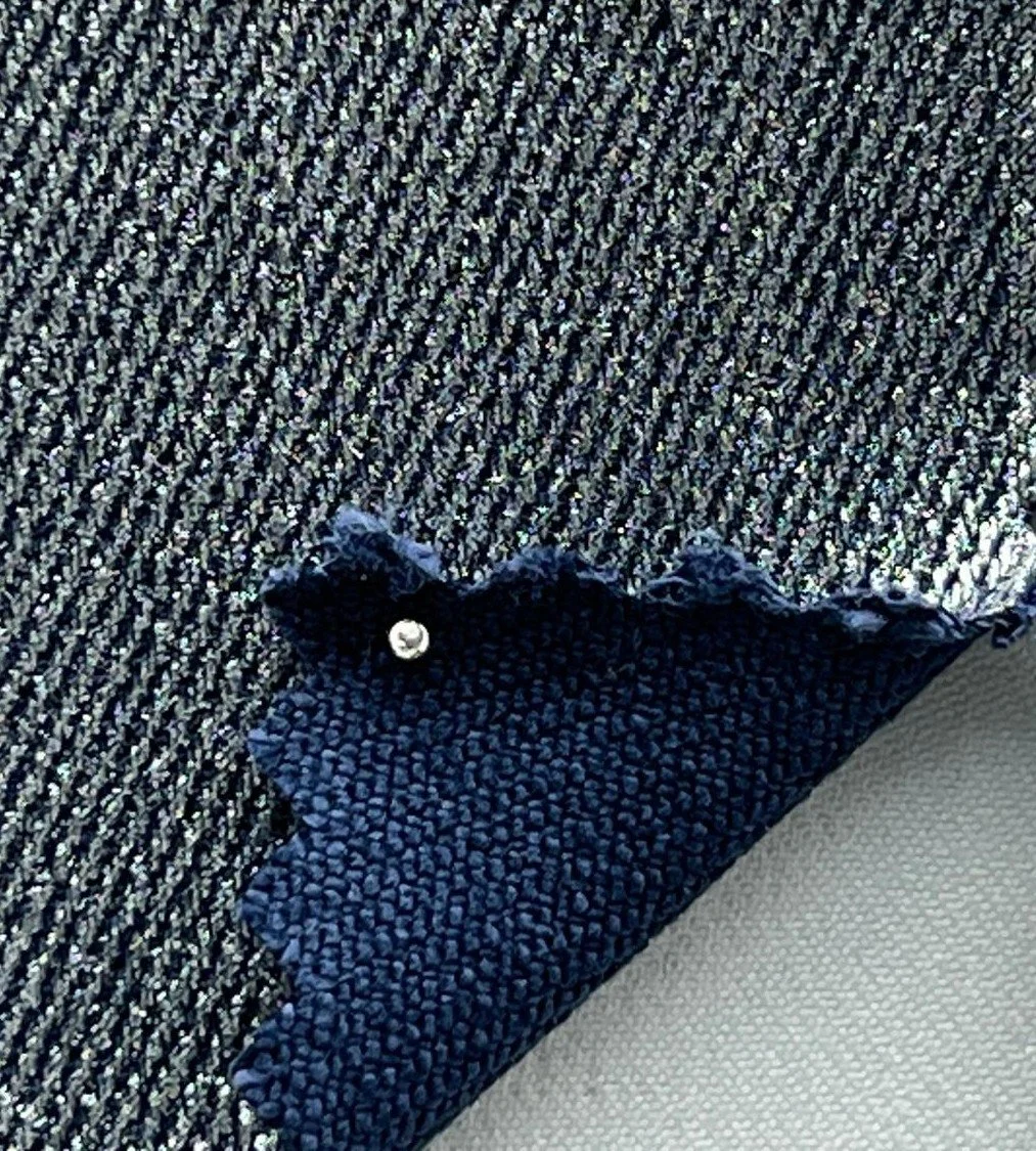 Close-up of moto pants fabric in gold navy