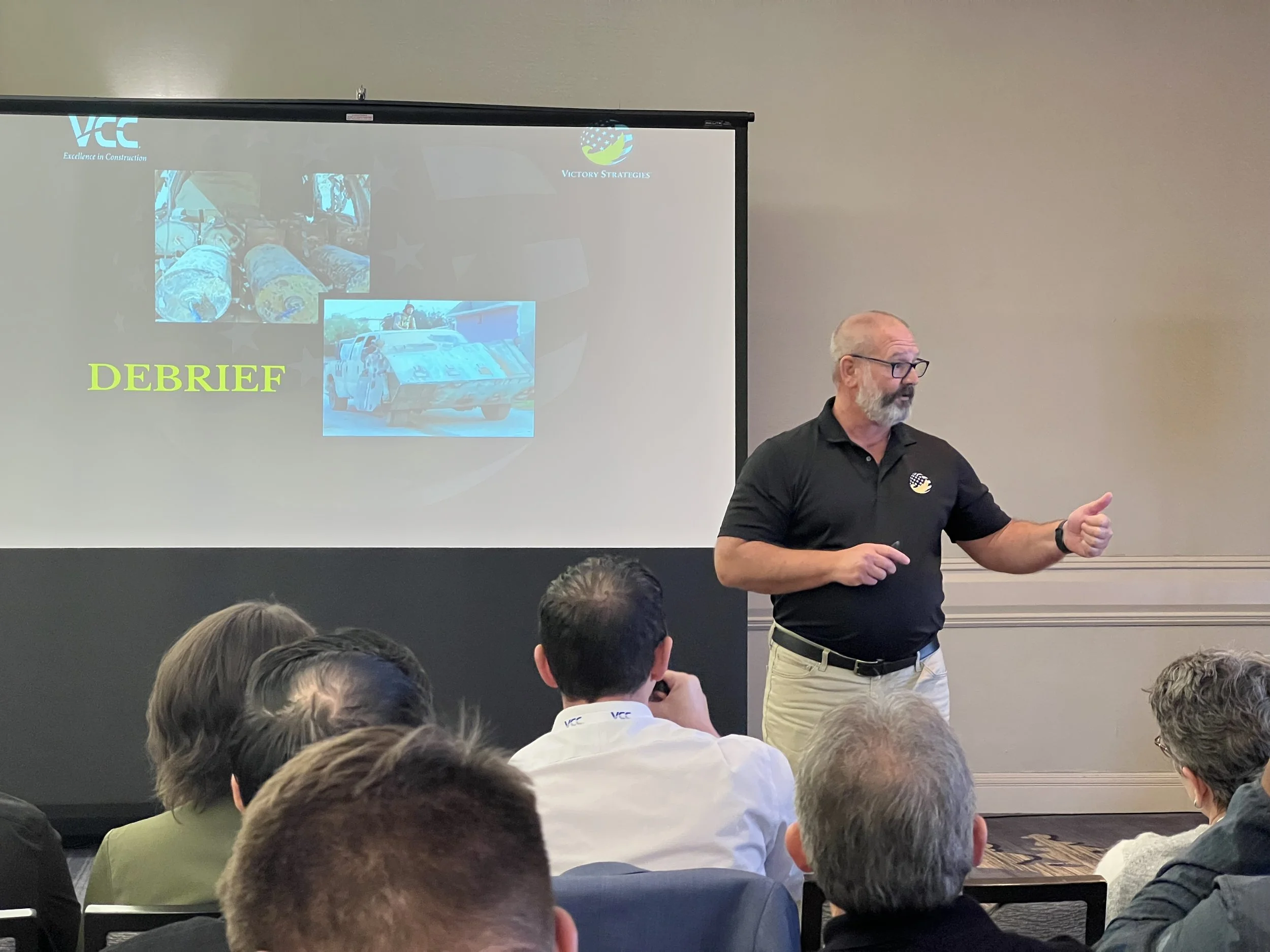 Man leading a workshop about the importance of debrief.