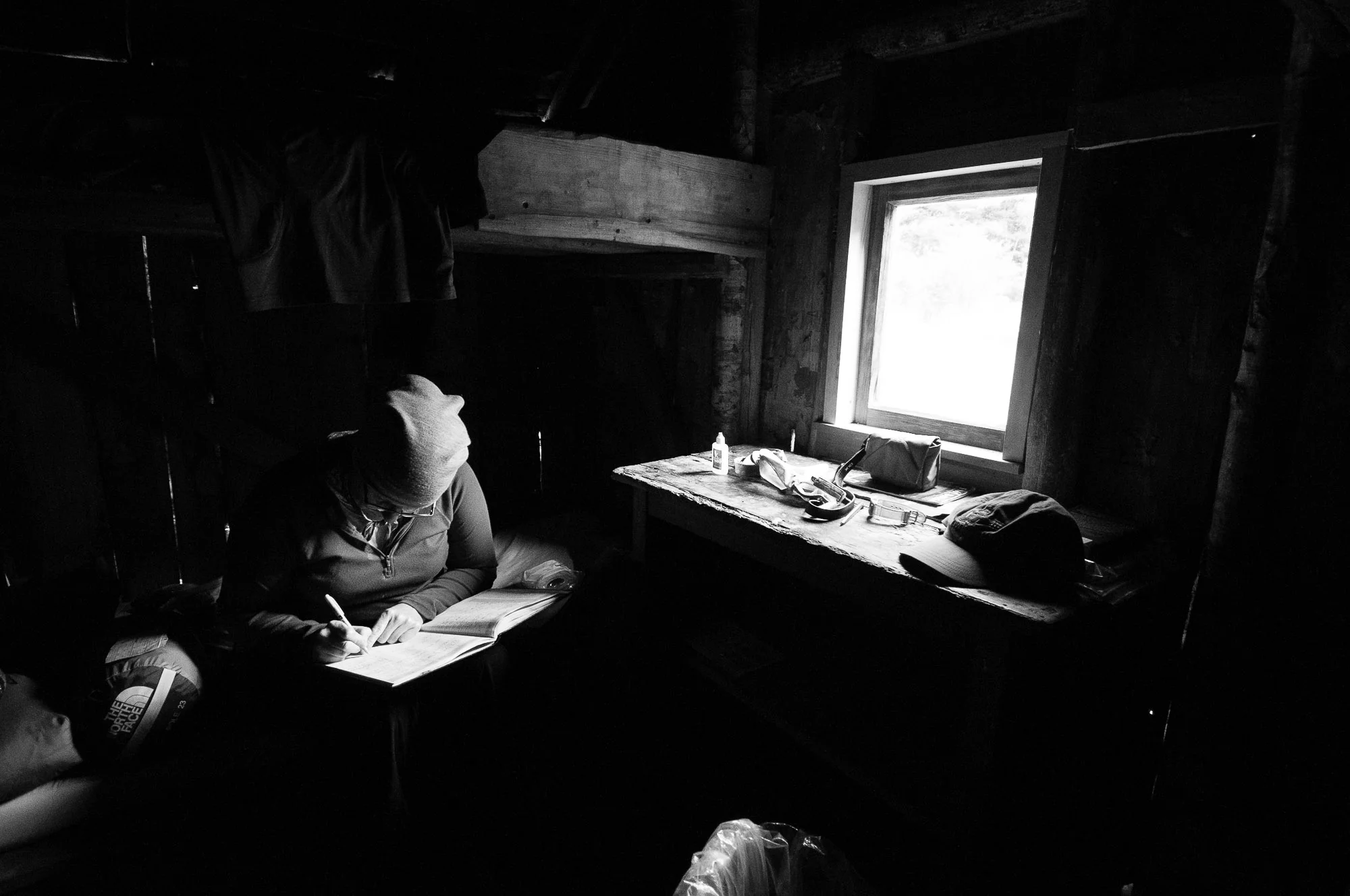 Filling in the log book at Cecil Kings Hut, New Zealand. © www.thomaspickard.com