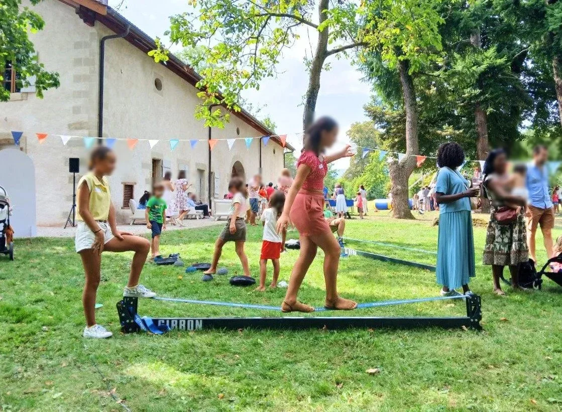 Slackline entertainment for kids and teens at a family event hosted by Slackline Events in a wooded park.