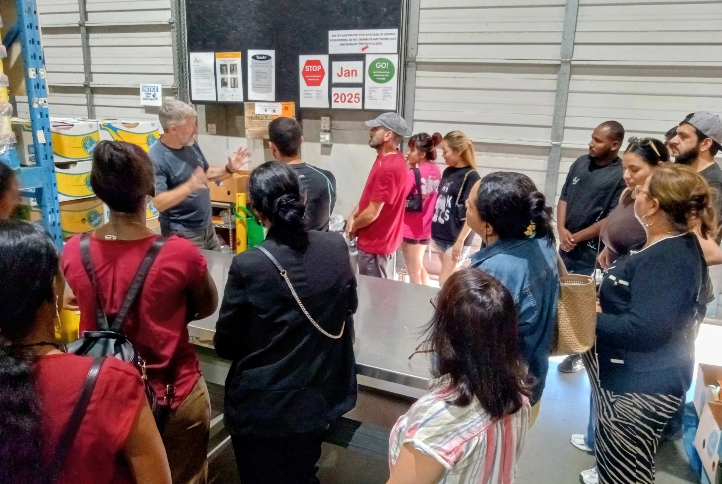 Students listening to John at the Food Bank.