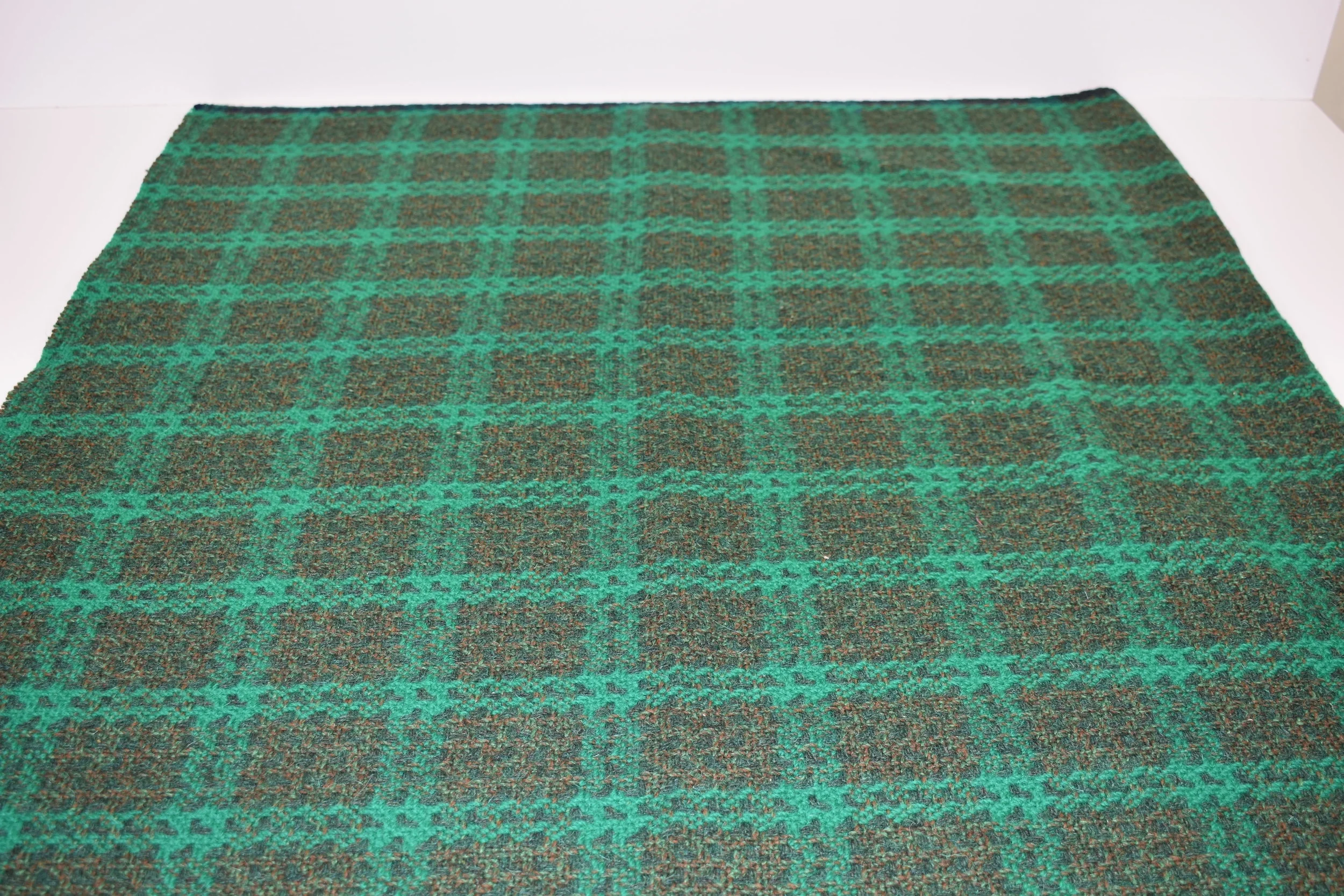  A green check woollen vintage fabric , perfect to make into a cosy throw .  