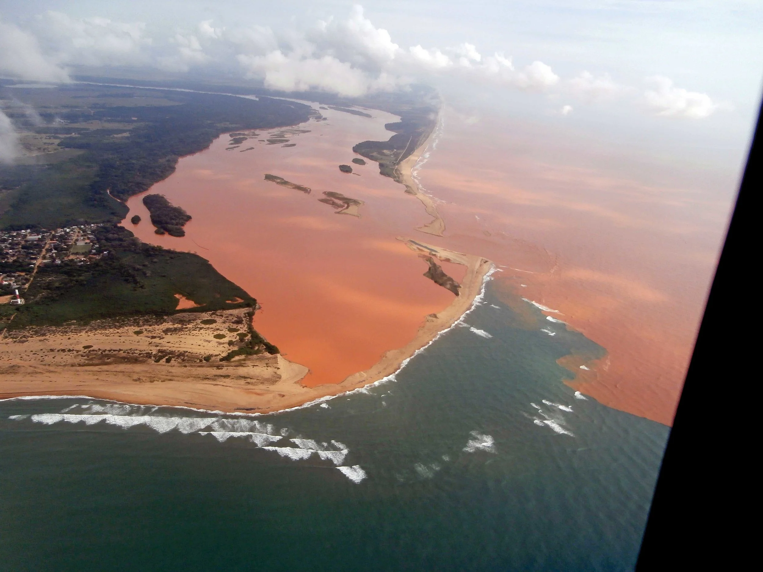 An aerial photograph of the mouth of Brazil’s Rio Doce shows the distant impact of a tailings dam failure 650 kilometers (404 miles) upstream. The beach is home to globally important leatherback and loggerhead nesting populations. © CENTRO TAMAR-ICMBIO