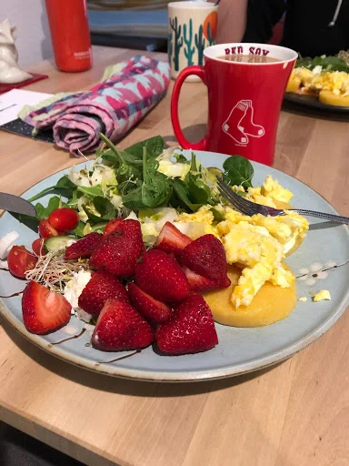 Usual breakfast: fruit, eggs, salad greens, polenta, olive oil, cucumbers, caffeinated beverage