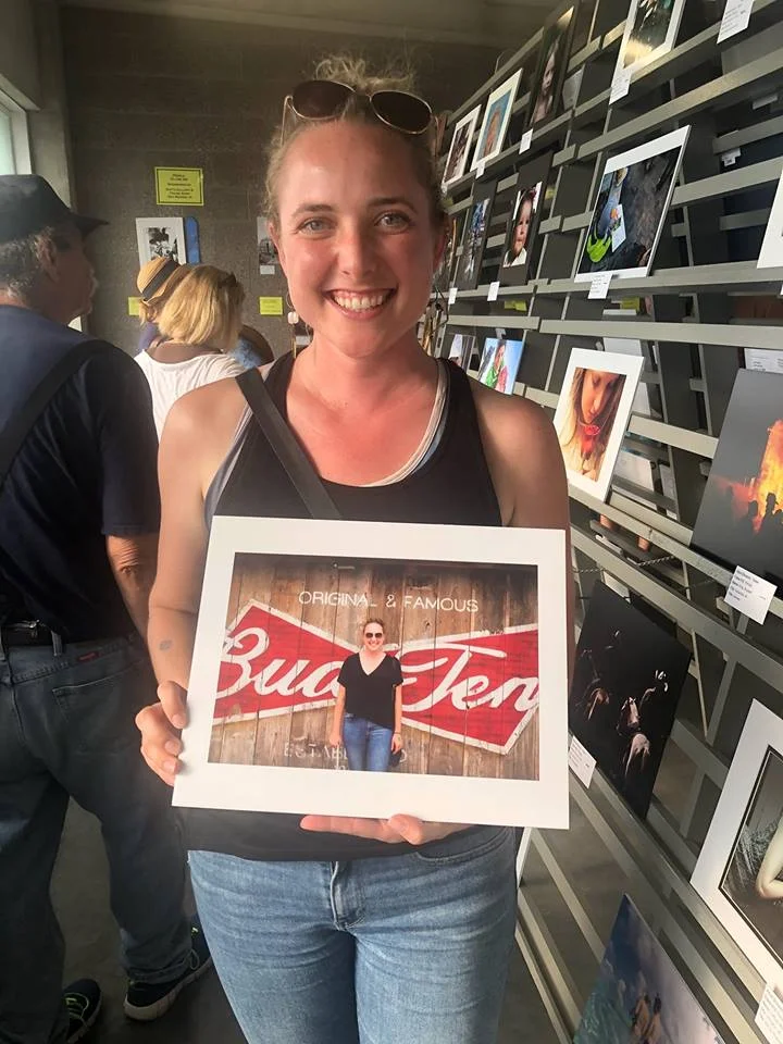 The former Ms. Winneshiek County poses with her photo. 