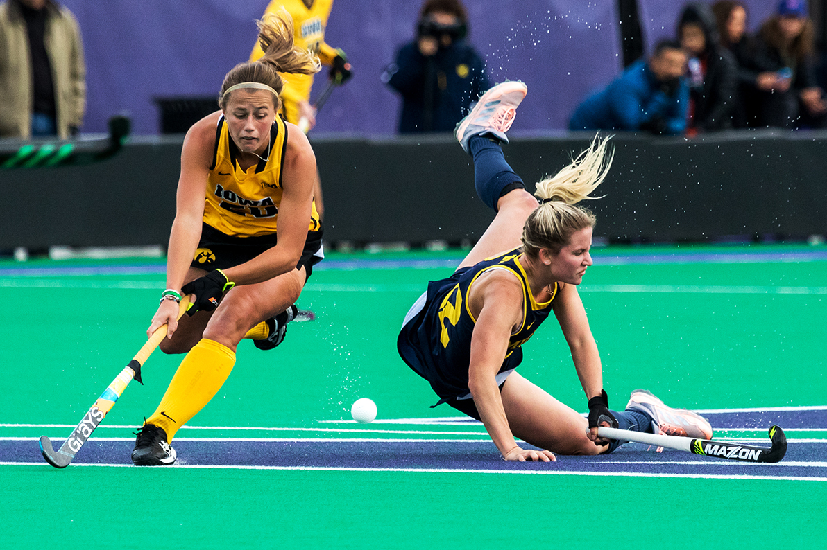  Iowa midfielder Sophie Sunderland tries to control the ball as a Michigan player crashes to the turf during the Semifinals in the Big Ten Field Hockey Tournament at Lakeside Field in Evanston, IL on Friday, Nov. 2, 2018. The no. 8 ranked Hawkeyes de