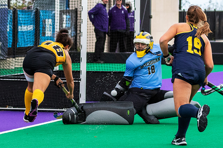  Iowa midfielder Mya Christopher slips a shot over the outstretched leg of Michigan goal keeper Anna Spieker during the Semifinals in the Big Ten Field Hockey Tournament at Lakeside Field in Evanston, IL on Friday, Nov. 2, 2018. The no. 8 ranked Hawk