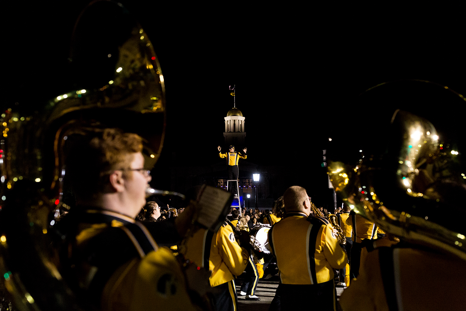  A member of the University of Iowa Marching Band directs the band during the 2018 Homecoming Parade in Iowa City on Friday, Oct. 19, 2019.  
