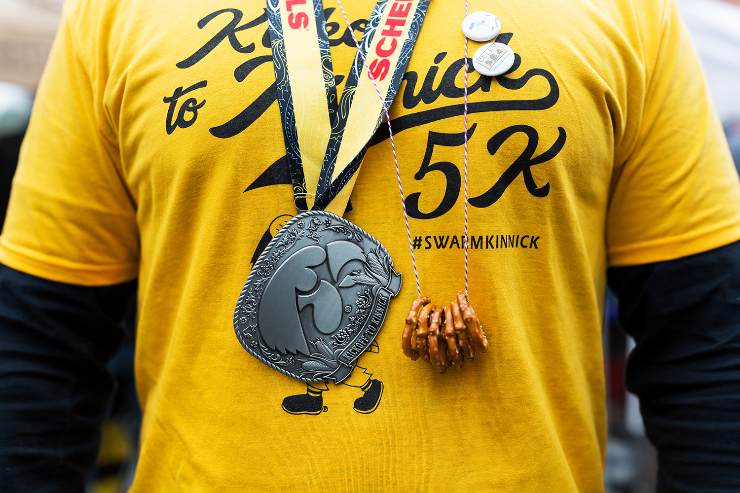  A participant in the Kickoff of Kinnick 5k race sports a medal and pretzel necklace at the Northside Oktoberfest in Iowa City on Saturday, Sep. 29, 2018.  