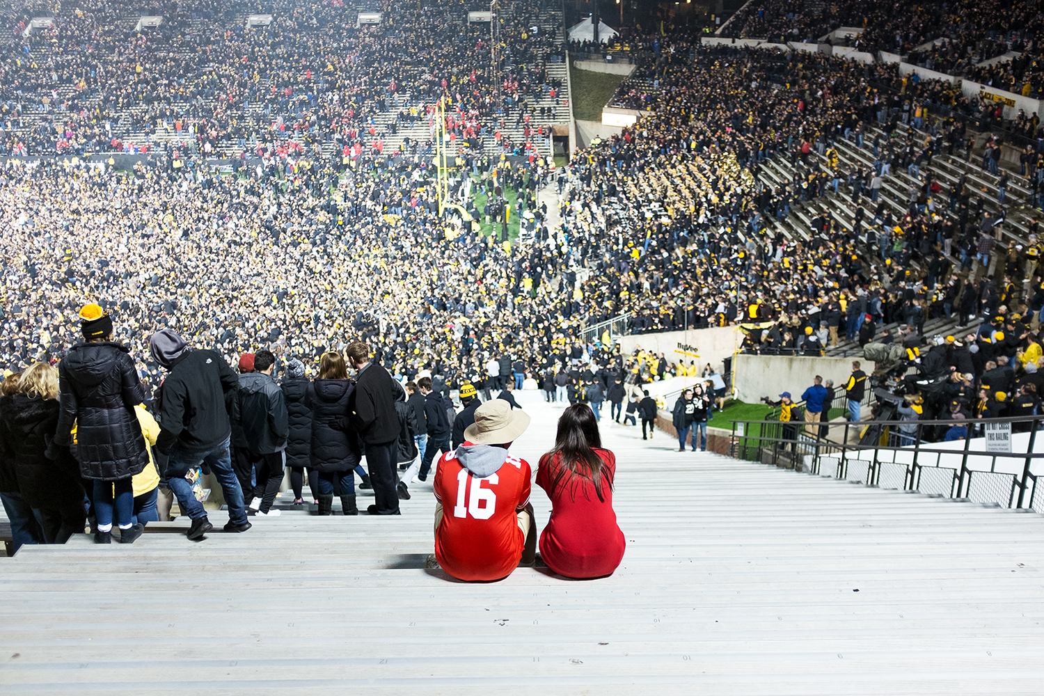  Ohio State fans sit in the stands at Kinnick Stadium as Iowa fans rush the field after the Hawkeyes crushed the Buckeyes 55-24 on Saturday, Nov. 4, 2017.  