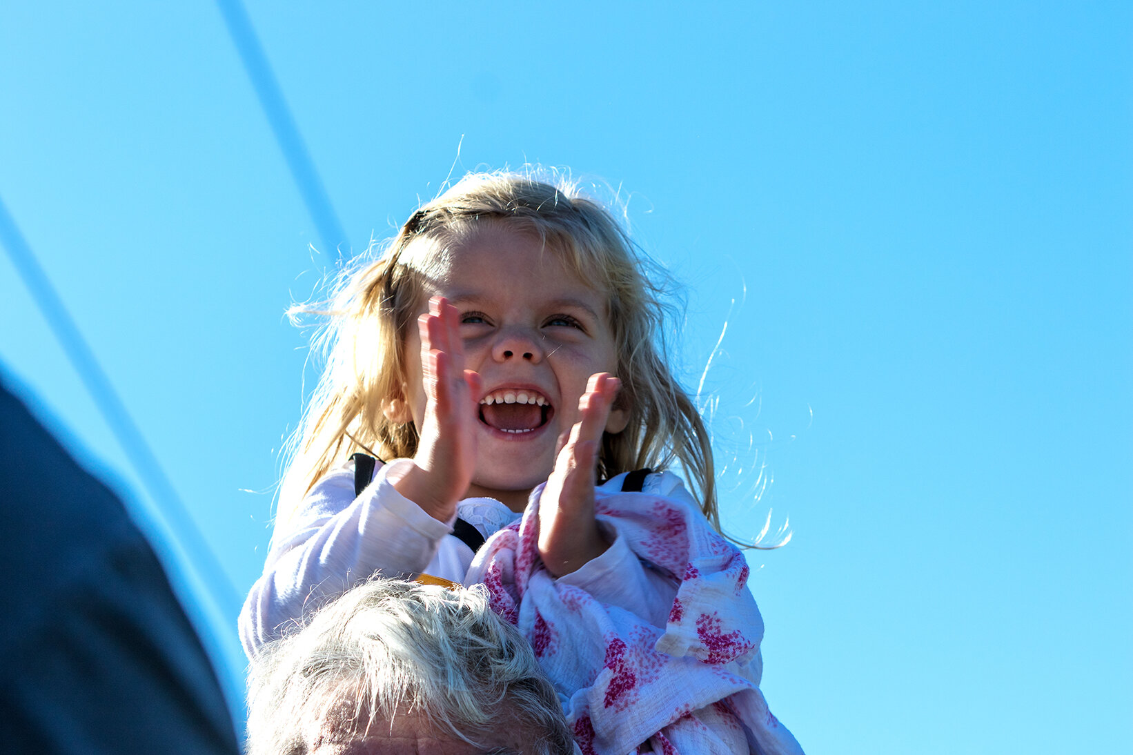  A young girl claps her hands as the Hawkeye Express arrives in Coralville, IA on Saturday, Sept. 22, 2018.  