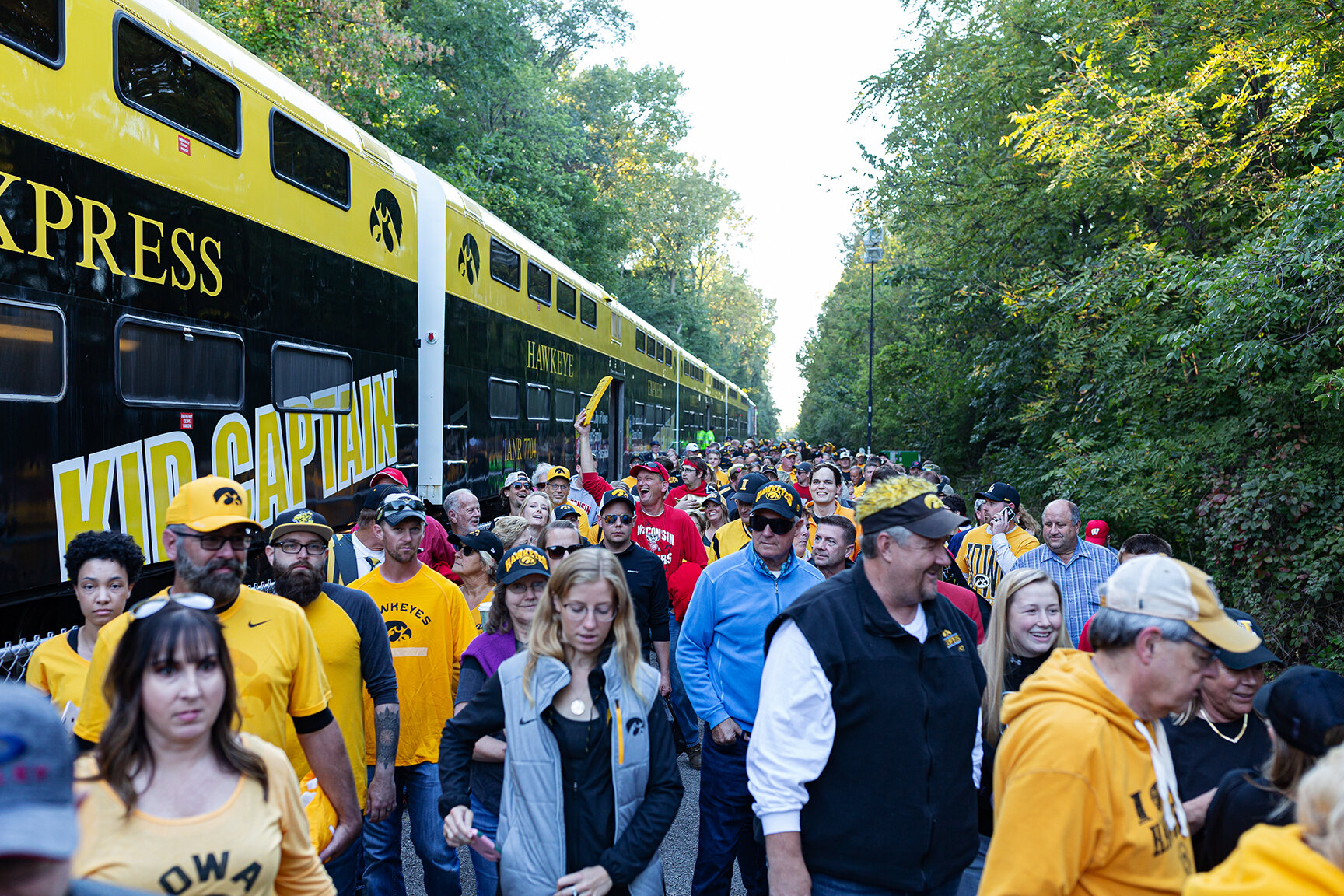  Fans spill out of the Hawkeye Express after its arrival at Kinnick Stadium before the football game against Wisconsin on Saturday, Sept. 22, 2018.  