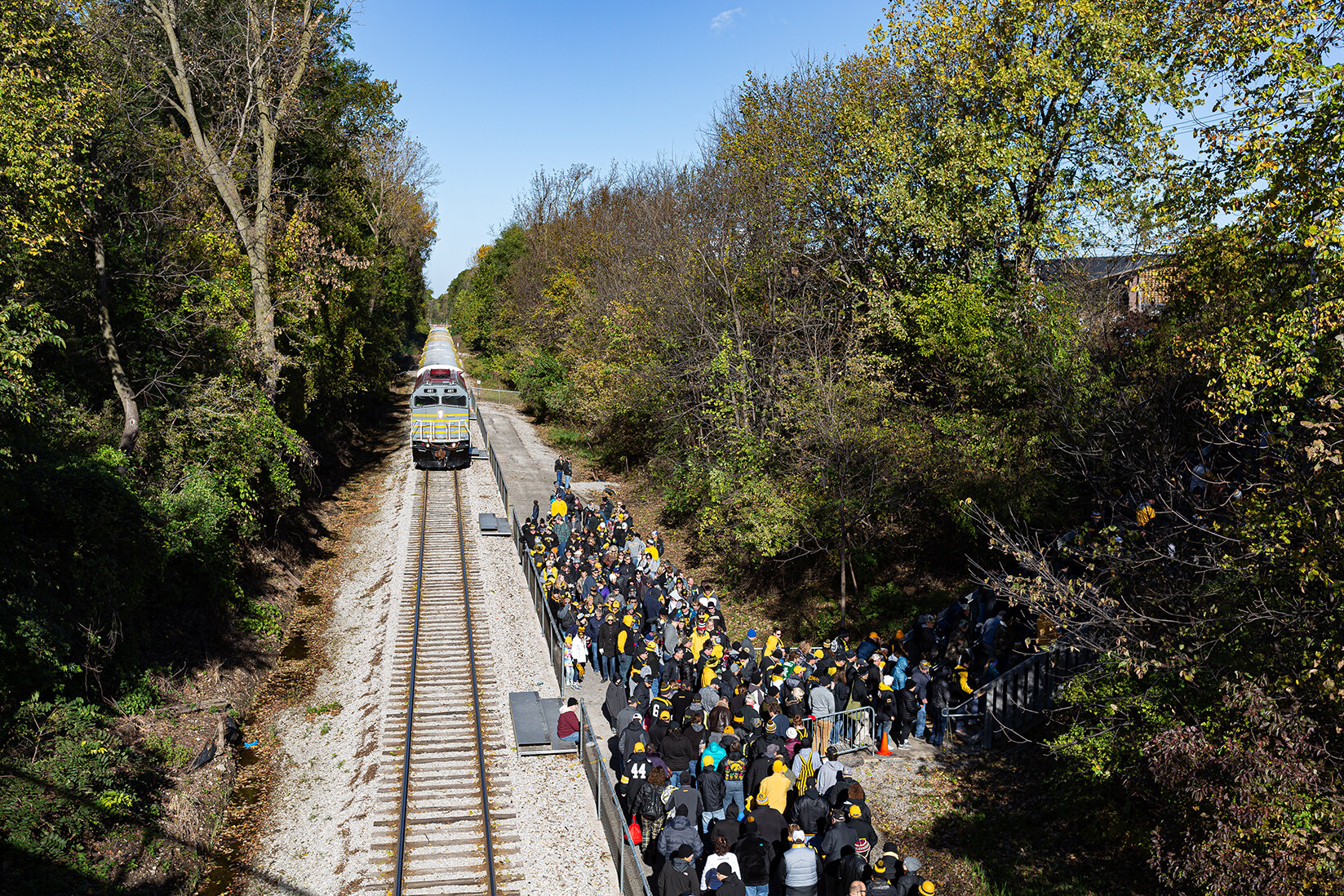  Fans wait to climb the stairs to Kinnick Stadium as the Hawkeye Express departs for another trip back to Coralville, IA  on Saturday, Oct. 20, 2018.  