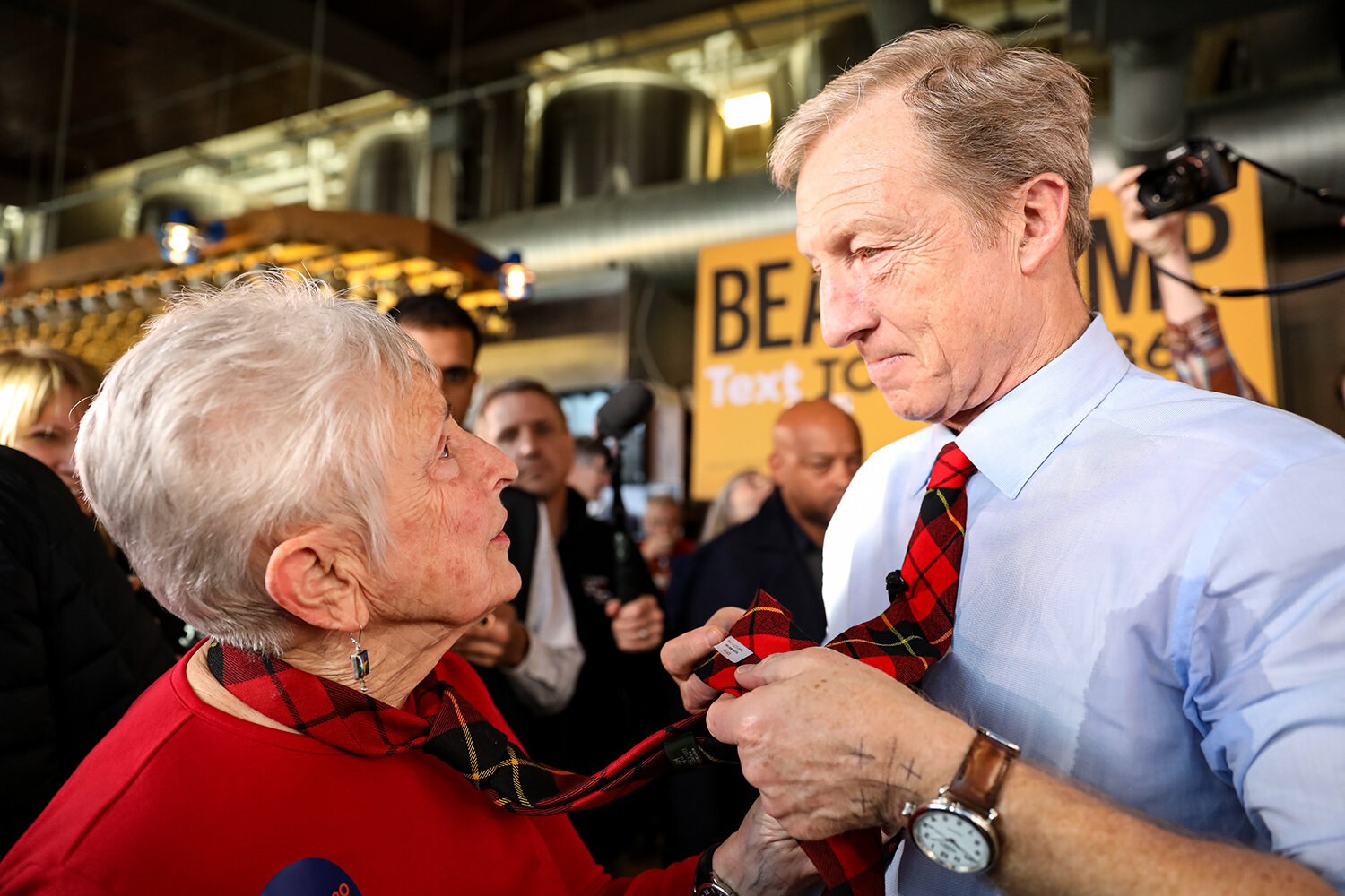  Mary Kathryn Wallace of Iowa City compares neckties with Democratic Presidential hopeful Tom Steyer after a Town Hall Meeting at Backpocket Brewing in Coralville, IA on Sunday, Feb. 2, 2020. Wallace is a caucus captain for Steyer and said that the p