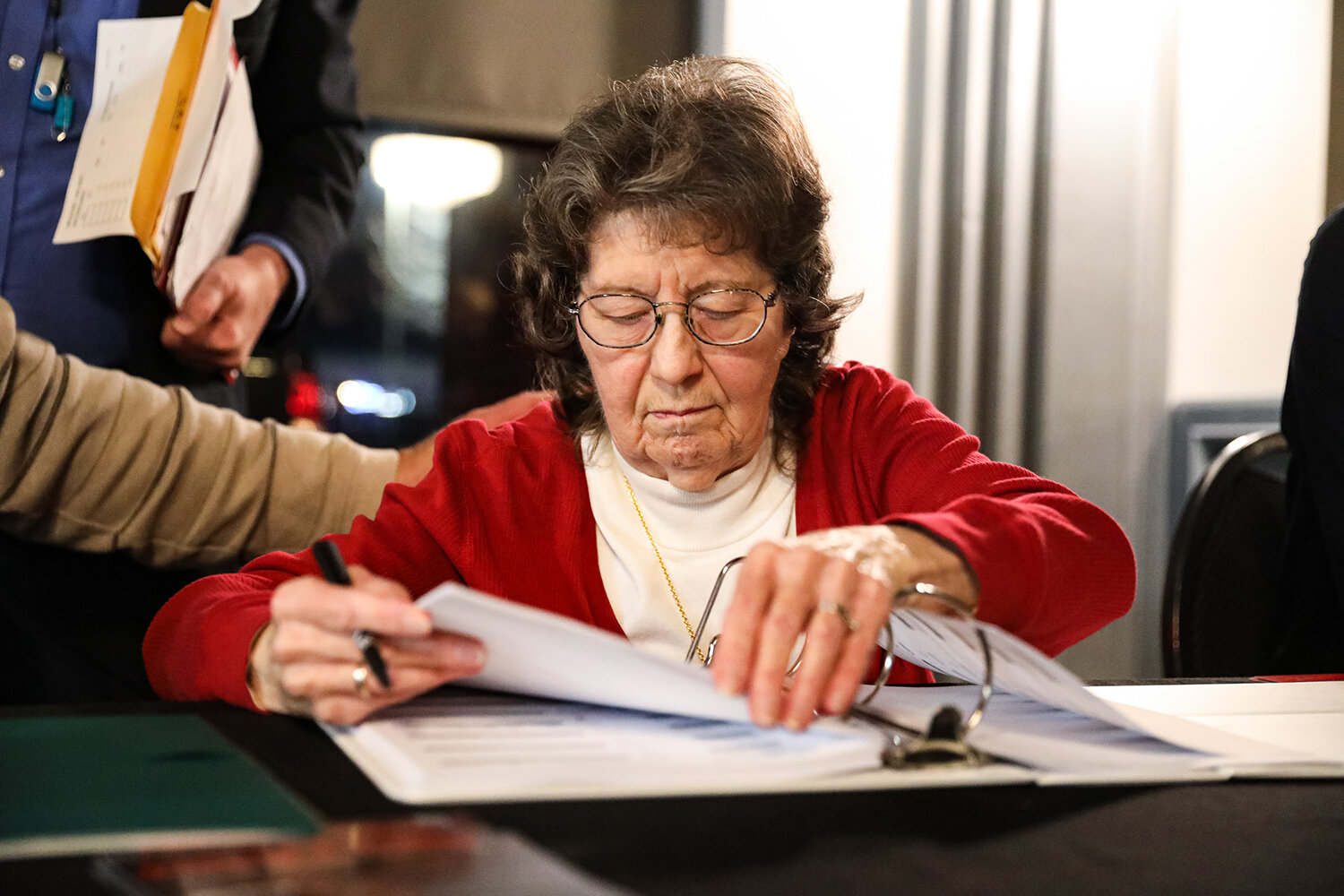  Sandra Wollcott of Cedar Rapids checks in caucus-goers during the Republican Party Caucus at the Butcher Block Steakhouse in Cedar Rapids, IA on Monday, Feb 3, 2020.  