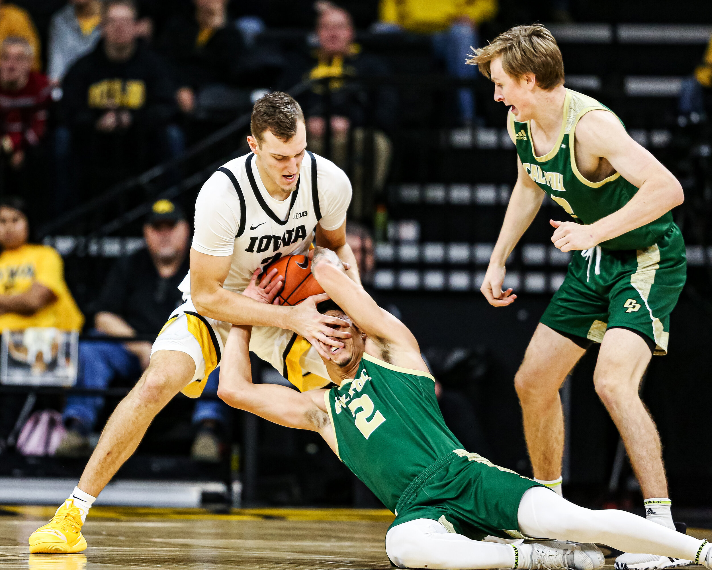  Iowa forward Jack Nunge (2) wrestles the ball away from Cal Poly forward Malek Harwell (2) during a basketball game against Cal Poly at Carver-Hawkeye Arena on Sunday, Nov. 24, 2019.  