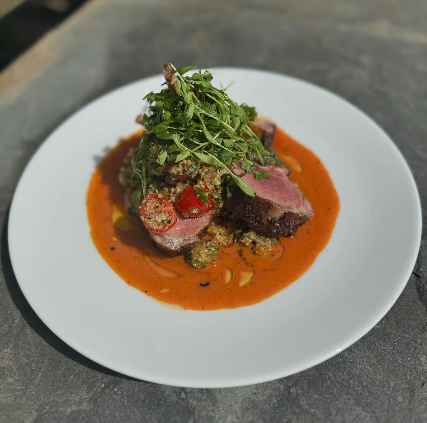 Urfa pepper roasted lamb rack, pistachio and mint pistou, grilled eggplant, warm couscous salad, and red pepper coulis.

This dish is the perfect thing to enjoy if you&rsquo;re ready for summer, perhaps on the back patio? Seating available when weath