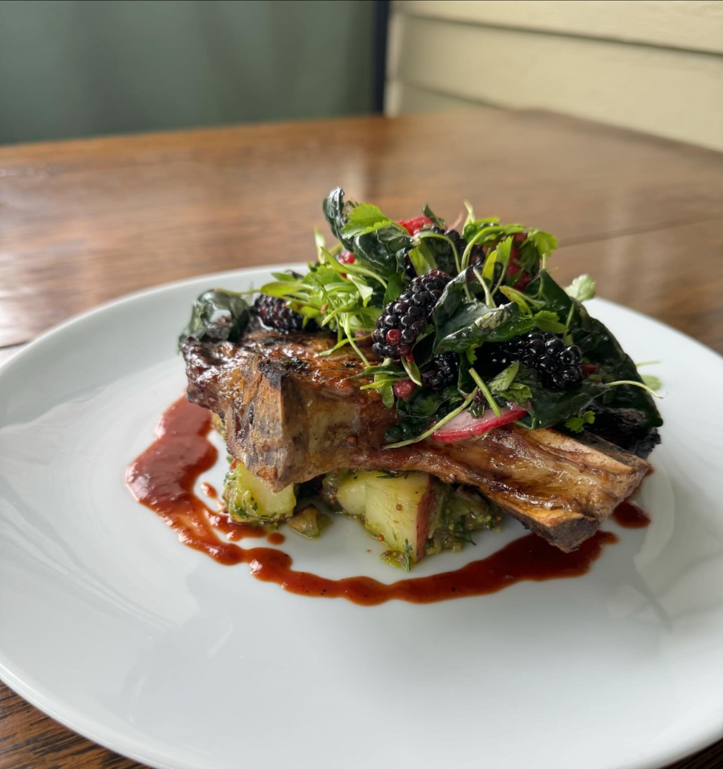 Grilled barbecue pork chop with ramp potato salad, guanciale, kale and berry salad, and berry gastrique. 

Come try this beautiful pork chop from Baker farm! It&rsquo;s the perfect thing to get you excited for summer! ☀️🍓🫐🐷