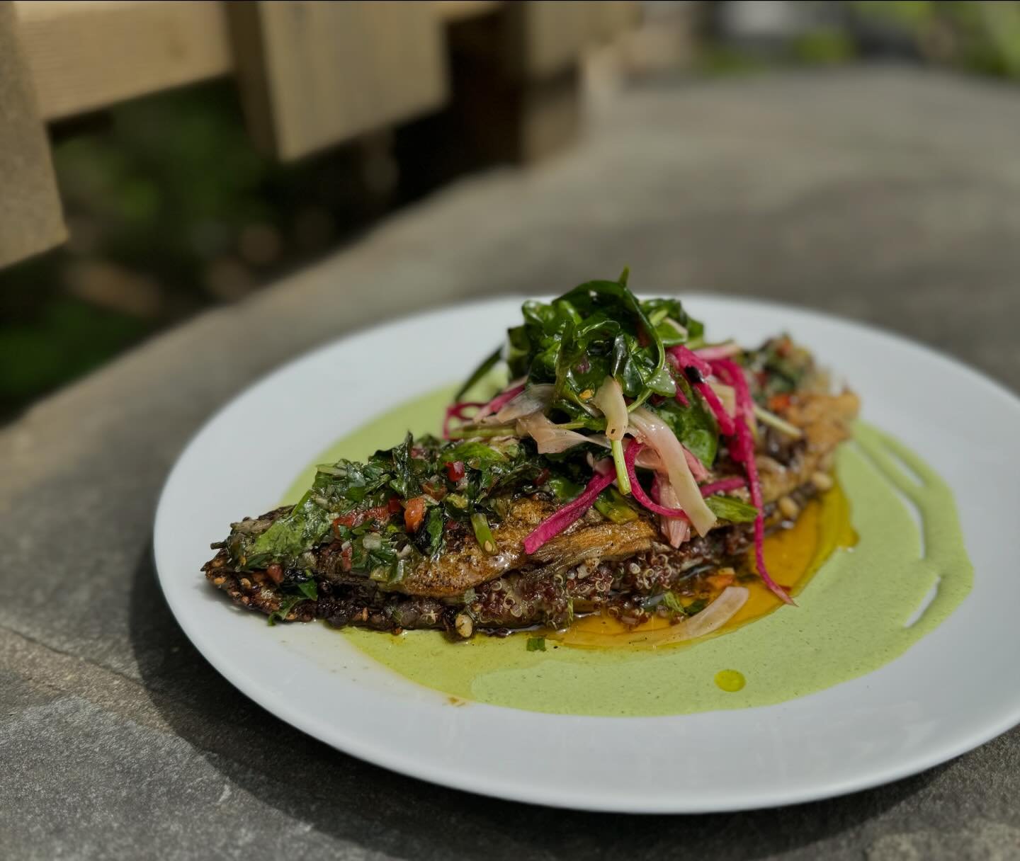 New to our dinner menu! Quinoa and za&rsquo;atar stuffed trout with green goddess, charred chimichurri, and fennel salad.