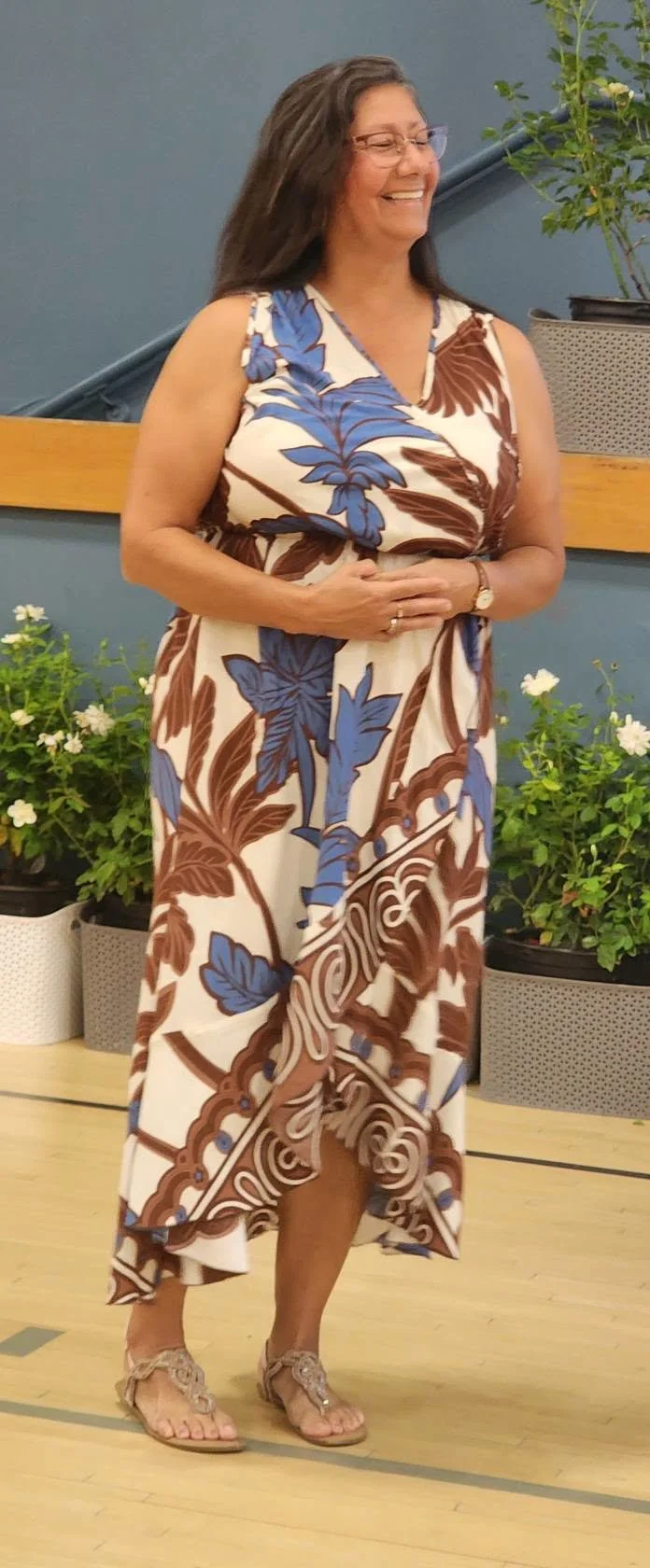A Mountain Vista teacher smiles in a patterned dress during a staff-service recognition ceremony.