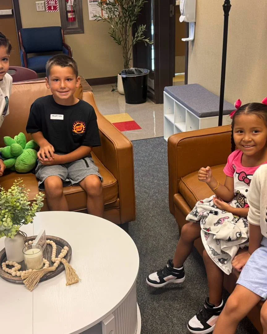 Students sit together in a comfortable school seating area.