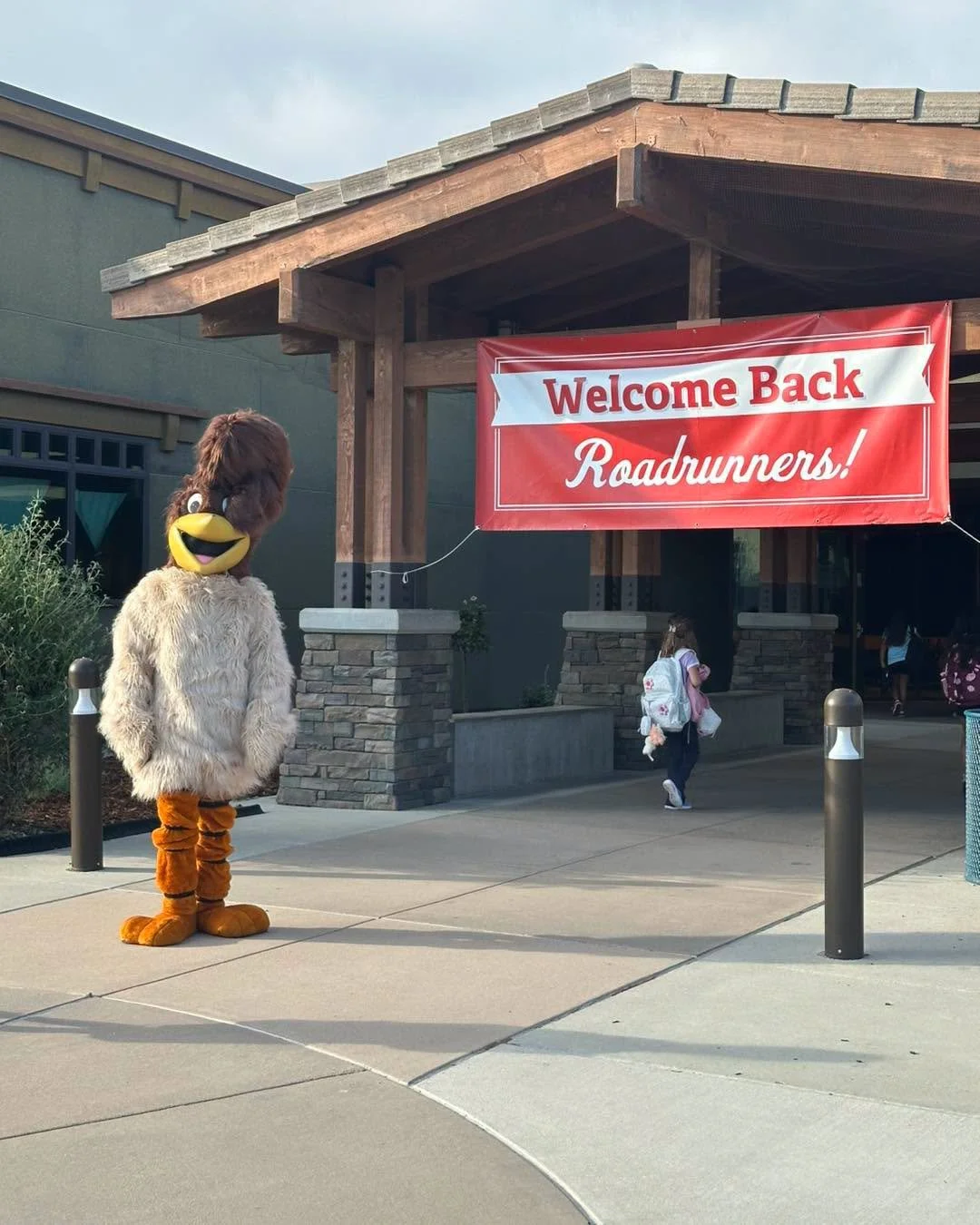 Ronnie the Roadrunner greets students at the Rio Vista entrance.
