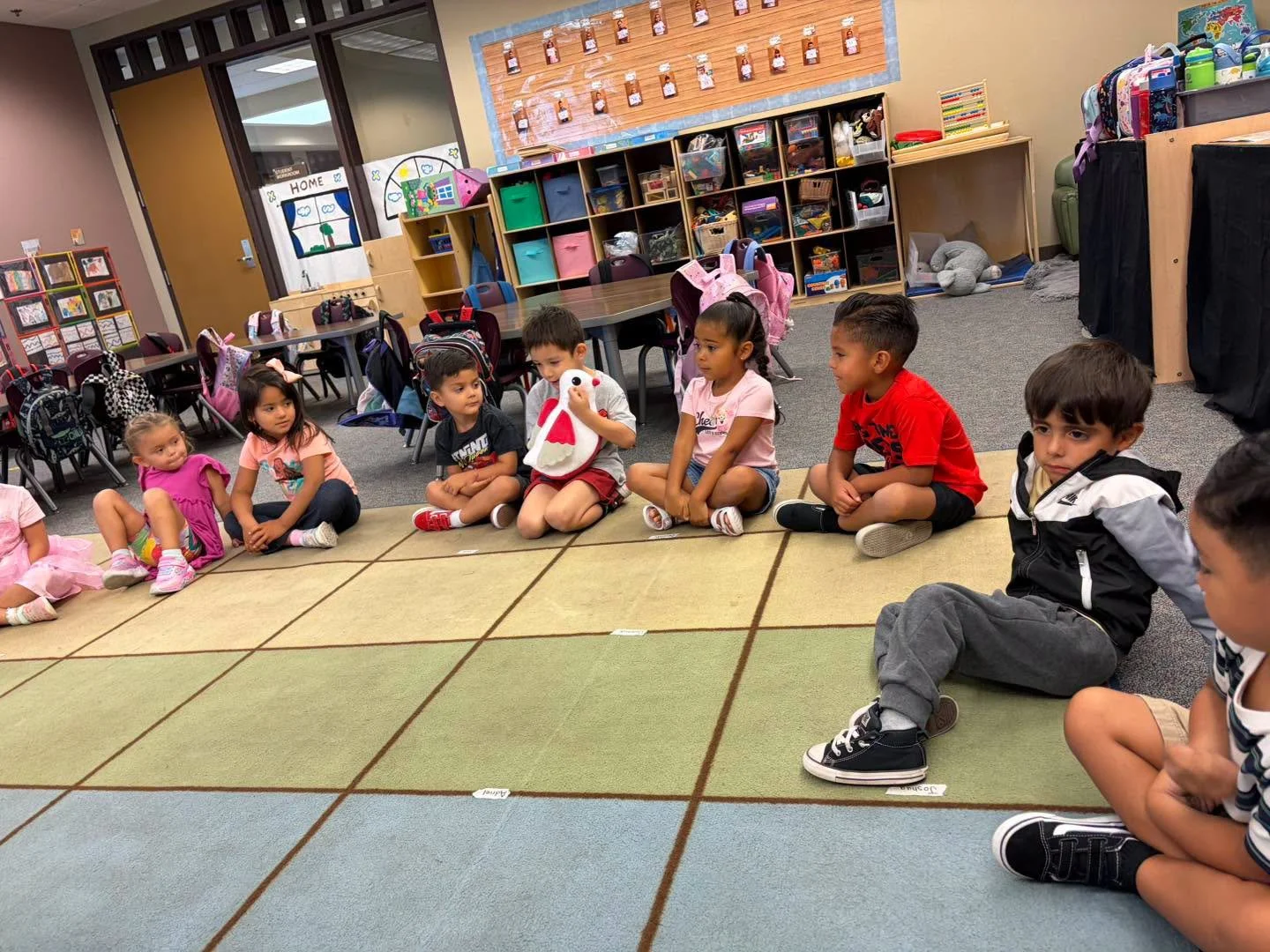 A student holds Lovey Dove during a class lesson about empathy and compassion.