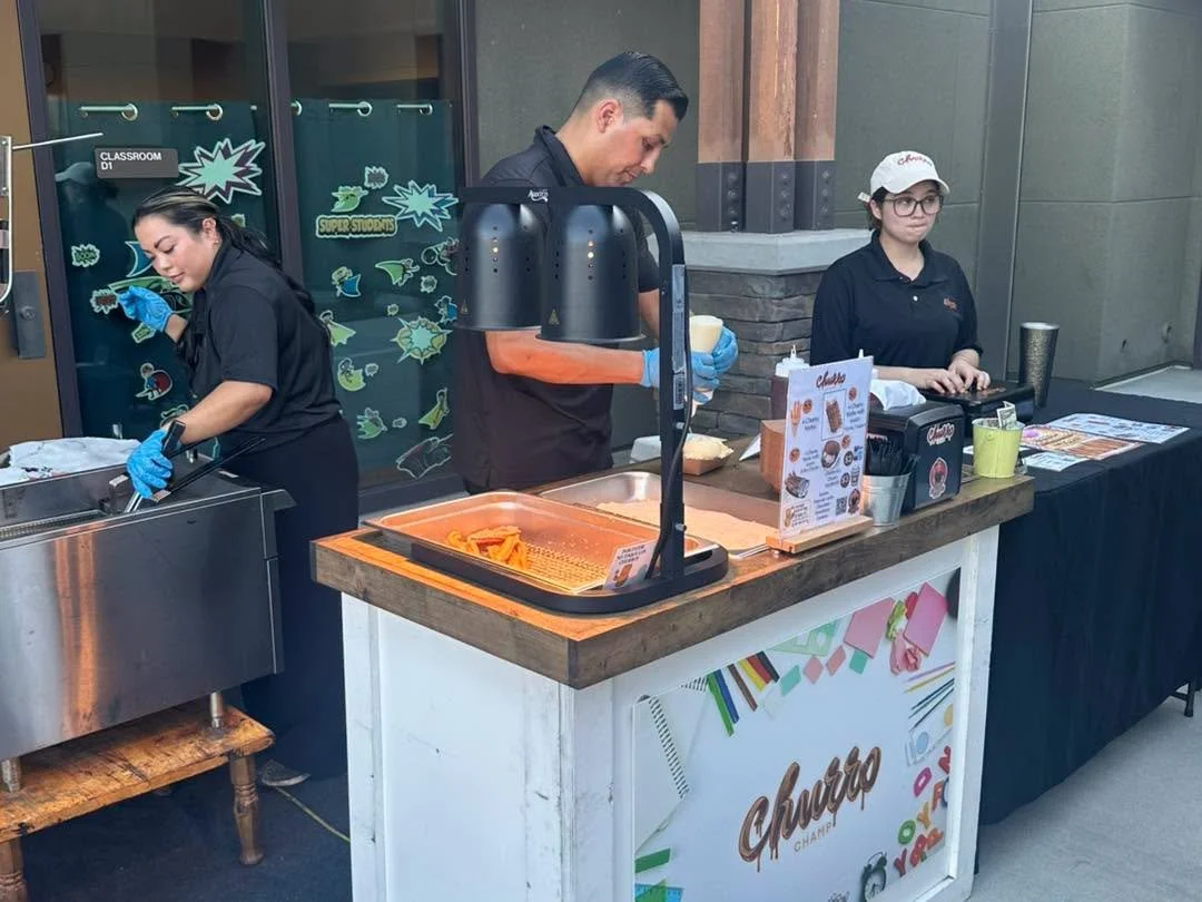 A churro stand serves treats during Family Game Night.