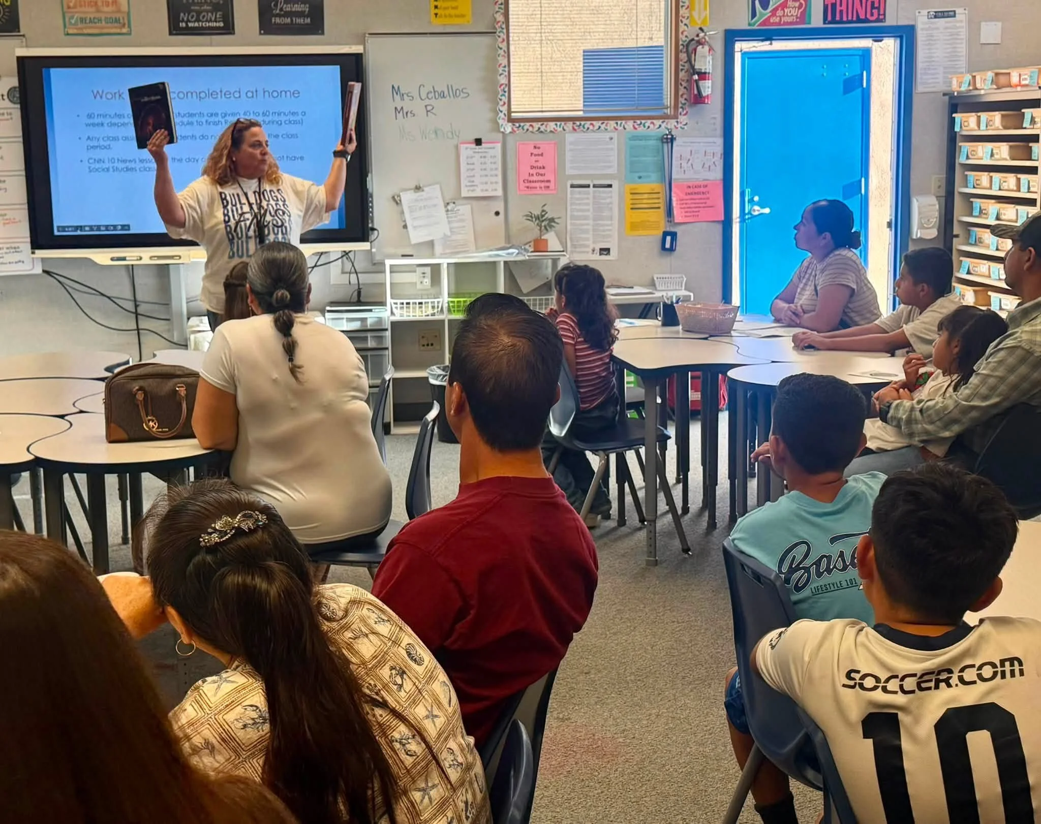 A teacher explains homework expectations to Bulldog families during Back to School Night.