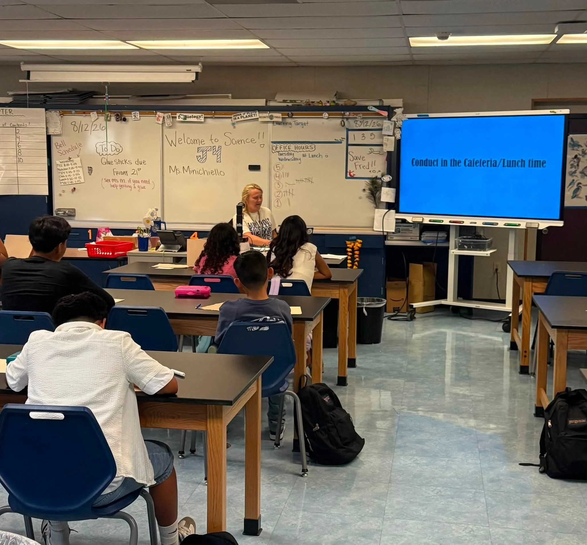 A teacher reviews cafeteria and lunchtime expectations with students.