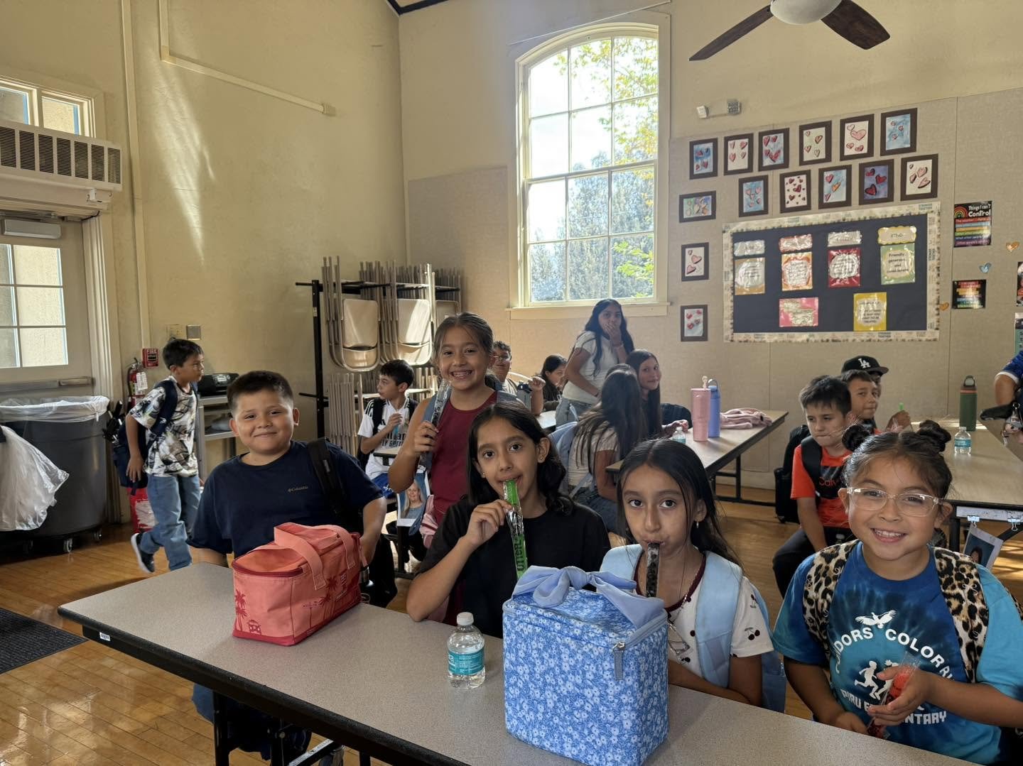 Piru students smile and enjoy Otter Pops in the cafeteria during an attendance celebration.