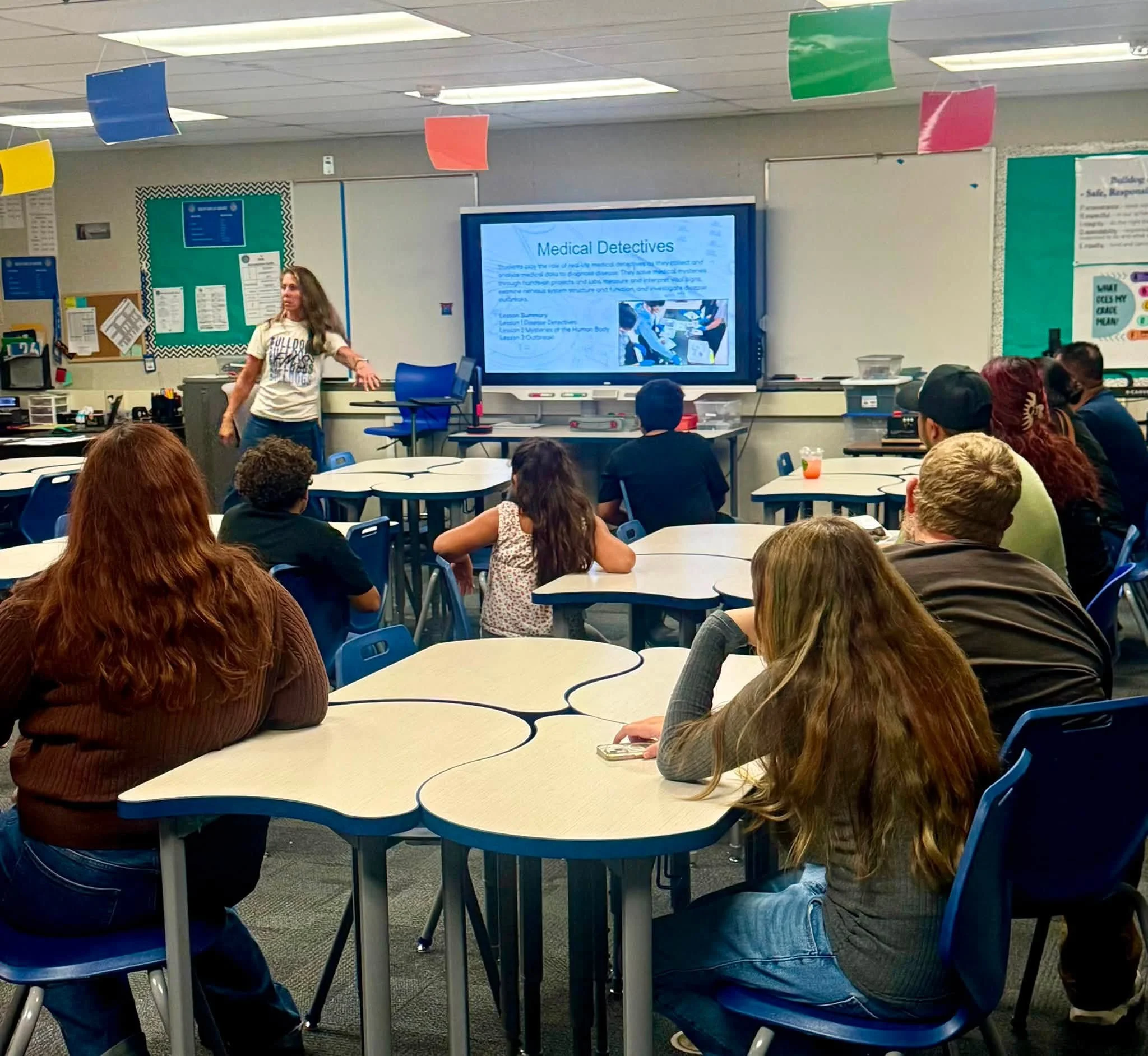 A teacher presents the Medical Detectives course to Bulldog families.