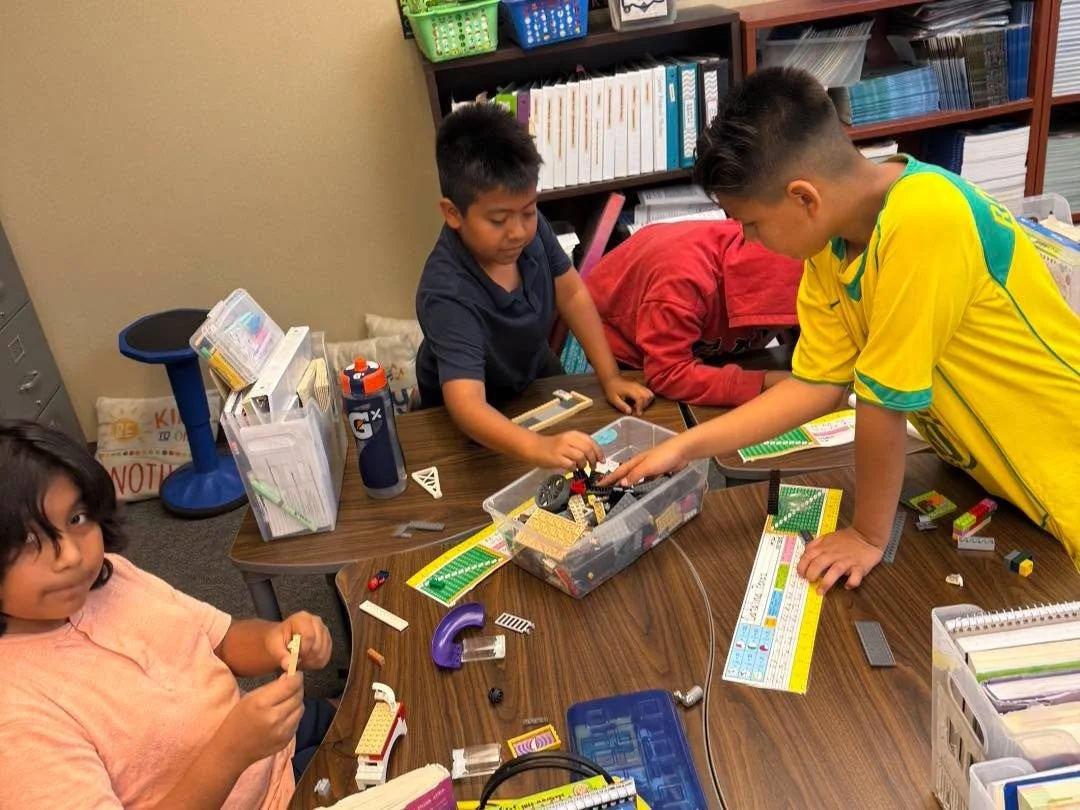 Roadrunners collaborate on a LEGO project.
