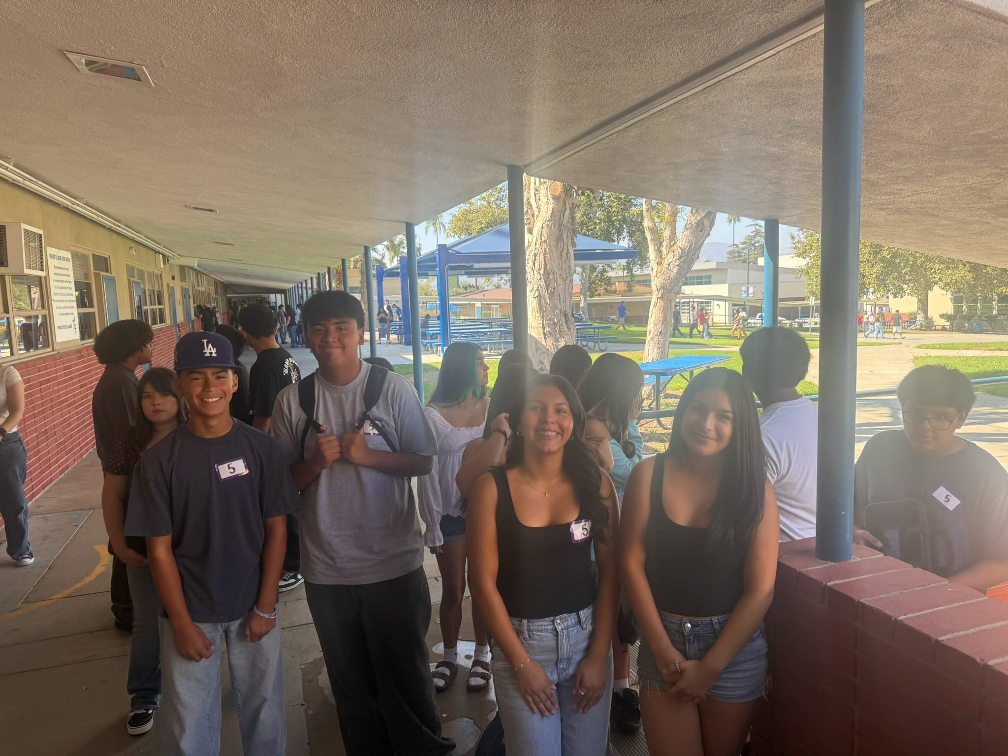 Students gather along a covered walkway during Fillmore High School registration.