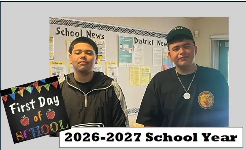 Two Sierra High students stand beside the school news bulletin board.