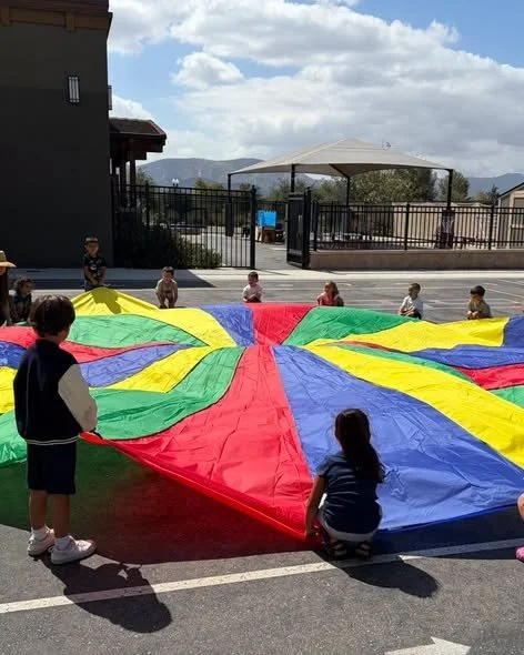 Roadrunners enjoy a parachute activity during physical education.