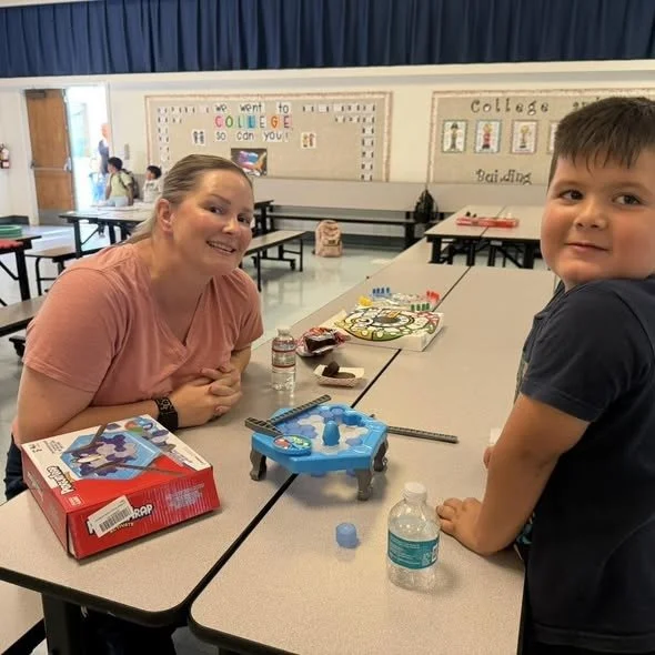 A student plays Sorry with a family member at San Cayetano Family Game Night.