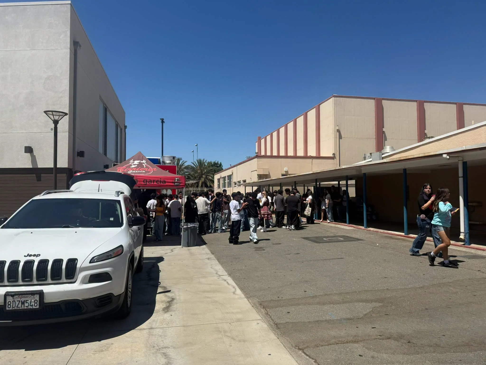 Students and families gather between campus buildings for Fillmore High School registration.