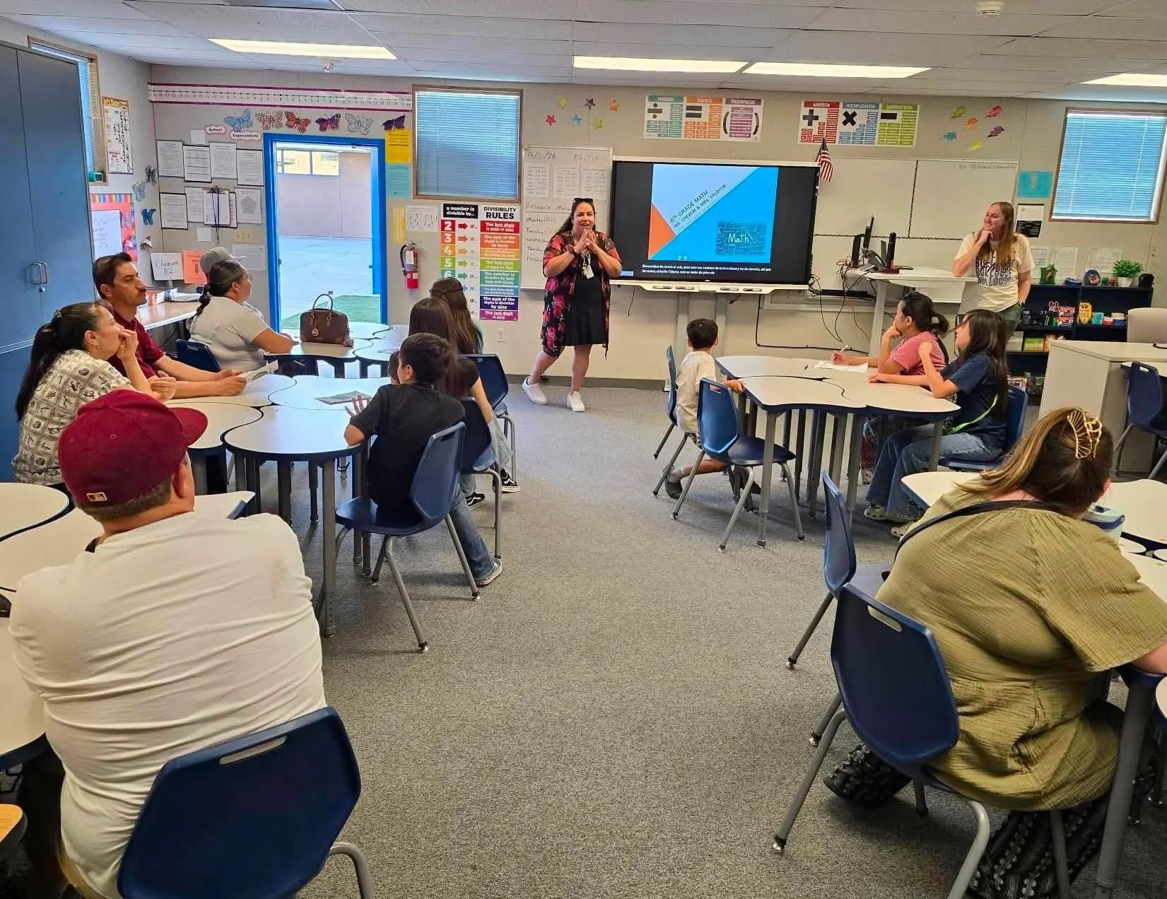 A math teacher speaks with Bulldog students and families during a classroom visit.