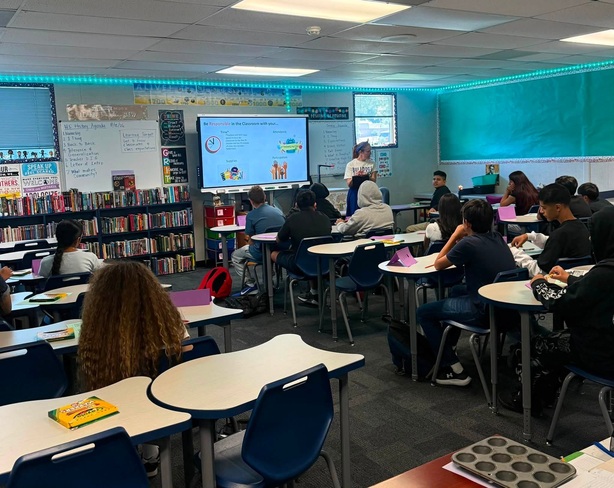 Students listen to a classroom presentation on the first day of school.