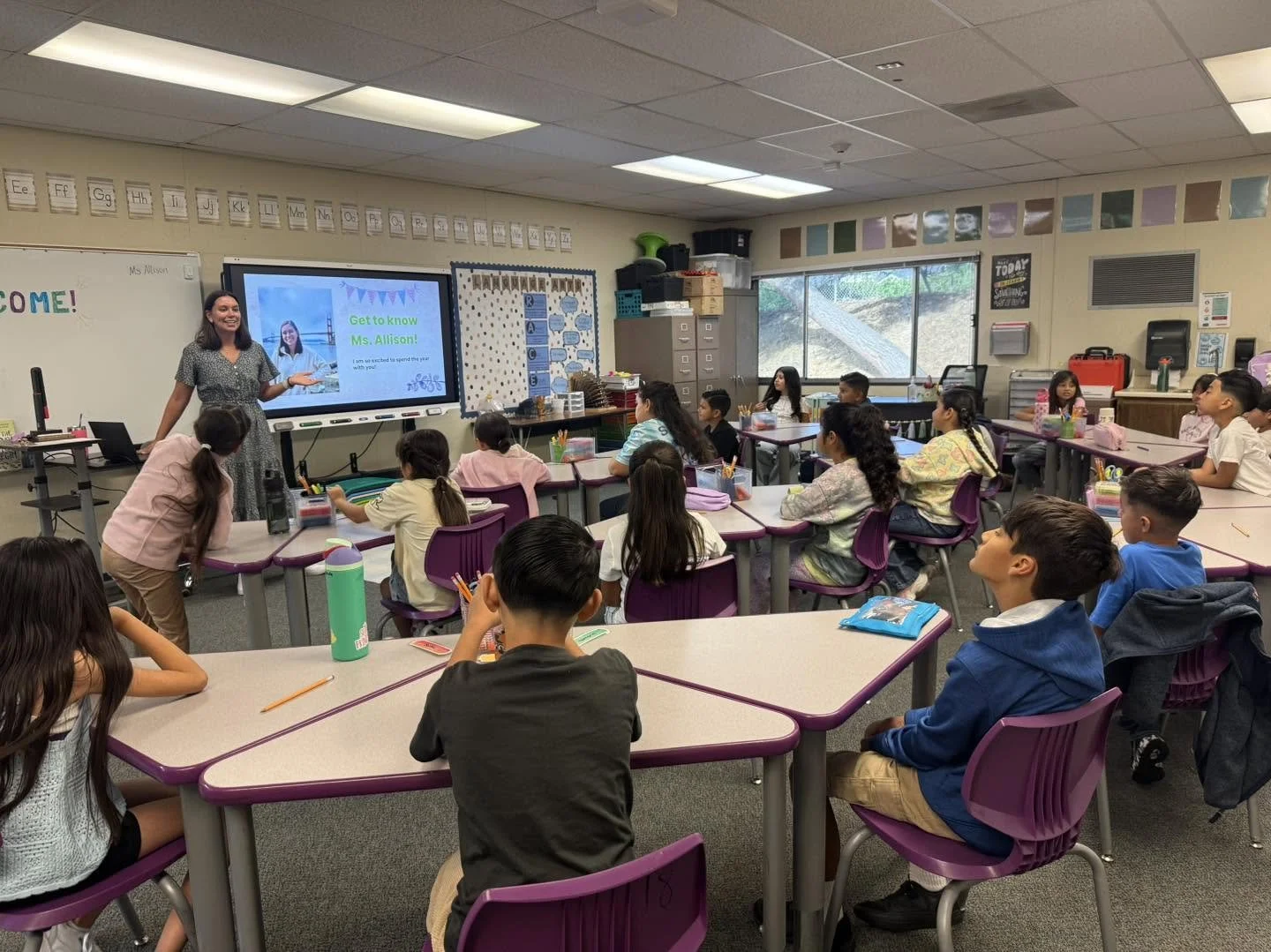 A teacher introduces herself to her class on the first day of school.