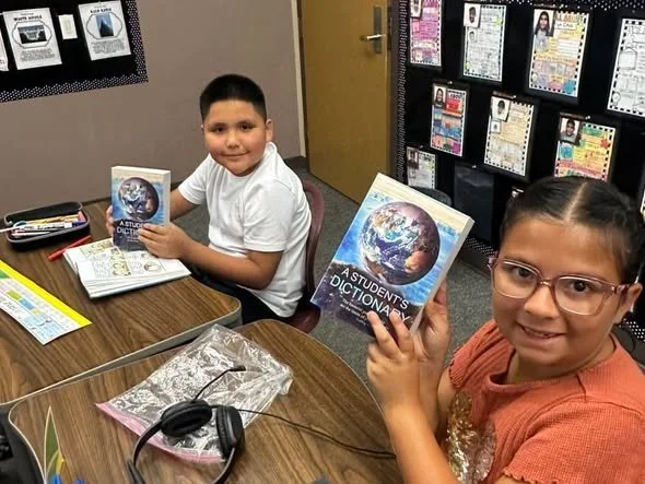 Roadrunners display the dictionaries they received.