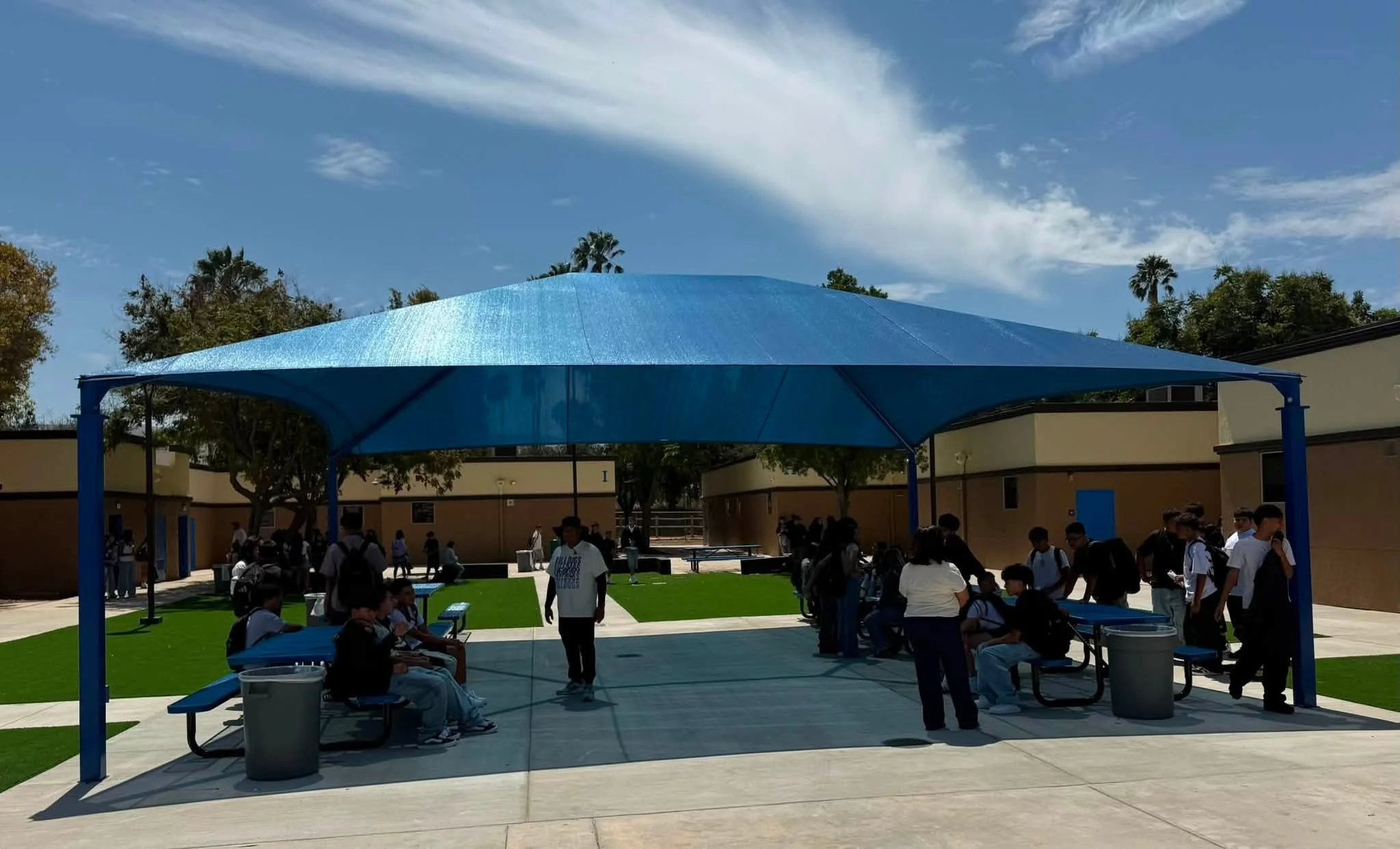 Students and staff enjoy the shaded courtyard seating area.
