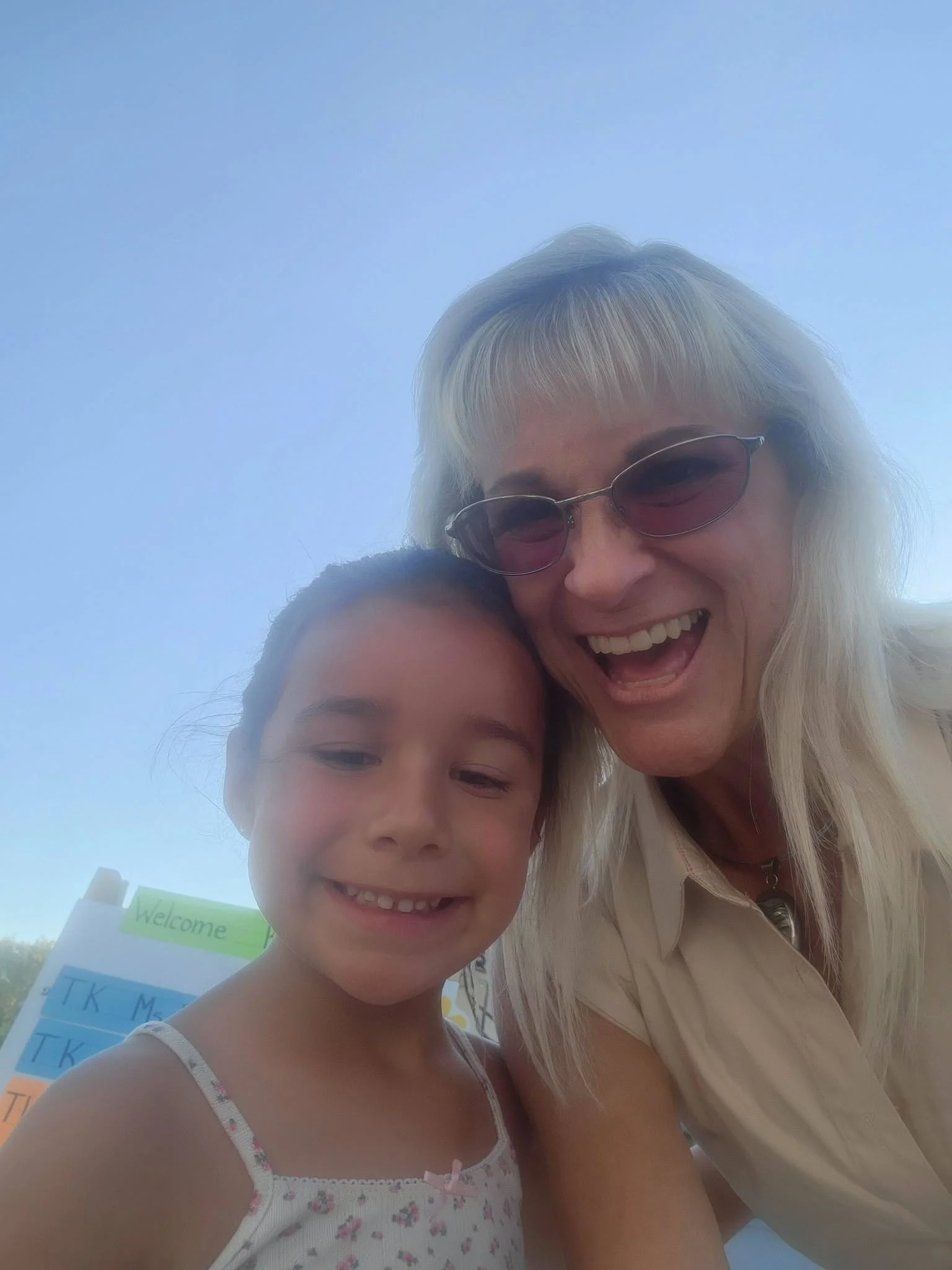 A young student and school staff member smile together during the Mountain Vista welcome event.