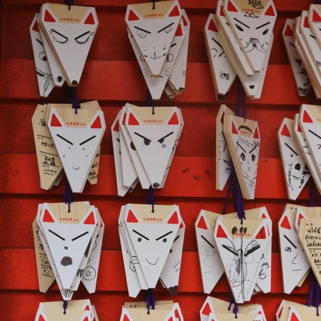 You can buy small wooden plates (ema) at the shrines, write a wish on them and hang it next to the other wishes. These were fox-themed, of course. I liked them so much and you can be sure I bought all the kitsune souvenirs for my friends!