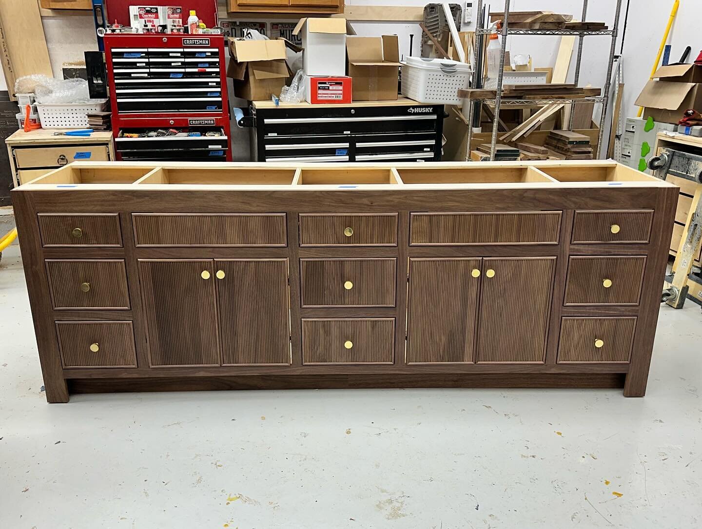 Custom 7.5&rsquo; inset vanity in walnut with reeded doors from @walzcraft and a tone matched clear finish from @newliferefinishing. Brass hardware completes this clean modern look, and it&rsquo;s now ready for a 4&rdquo; stone top in its forever hom